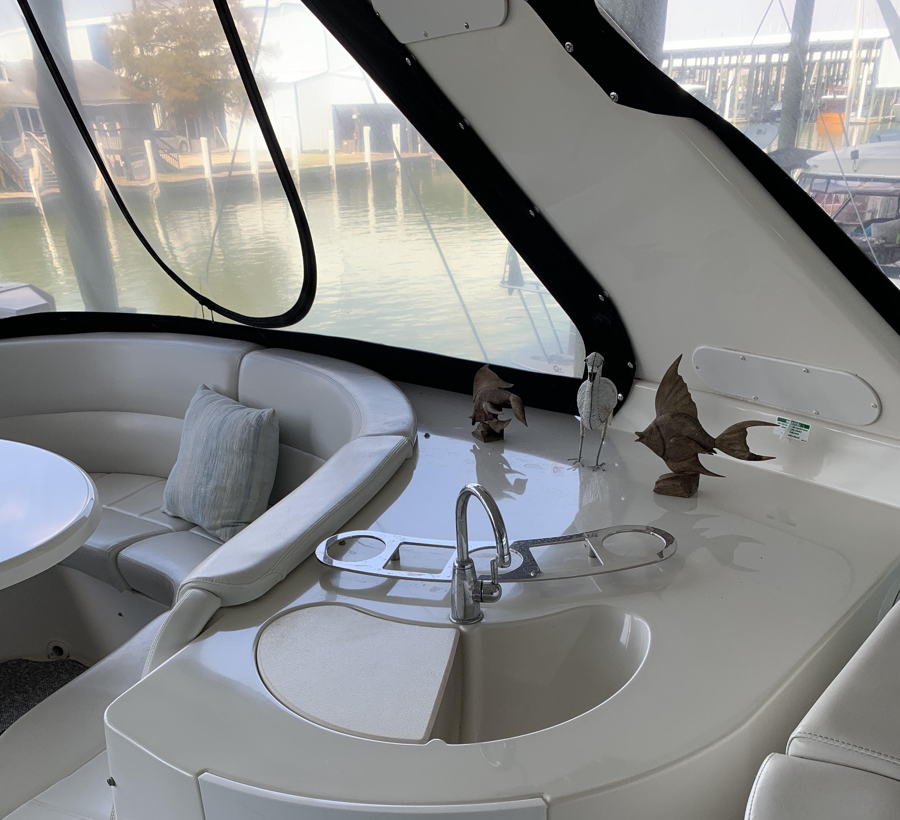 Luxurious 2007 Carver 56 Voyager yacht interior with seating and sink area.
