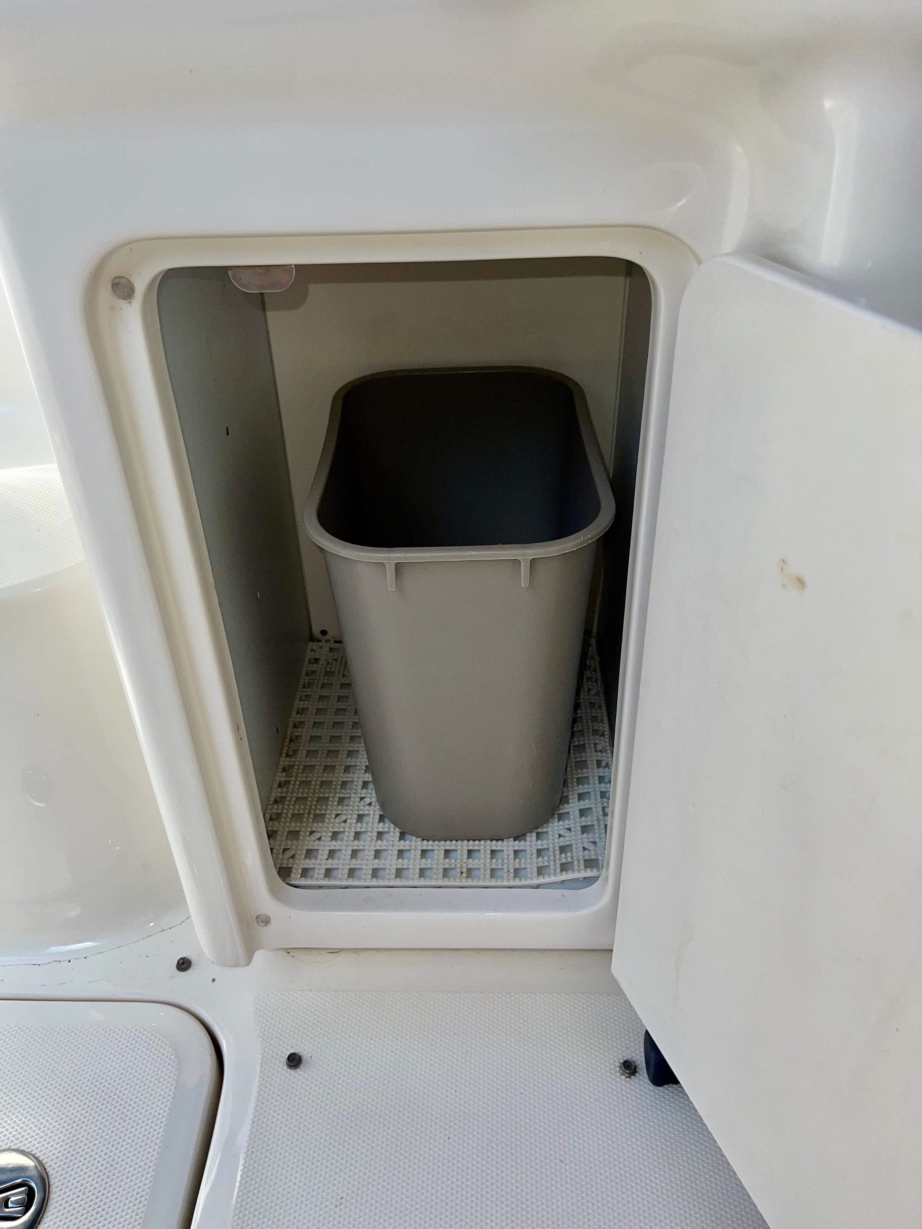 Built-in trash bin compartment on a 2008 Sea Ray 40 Sundancer boat.