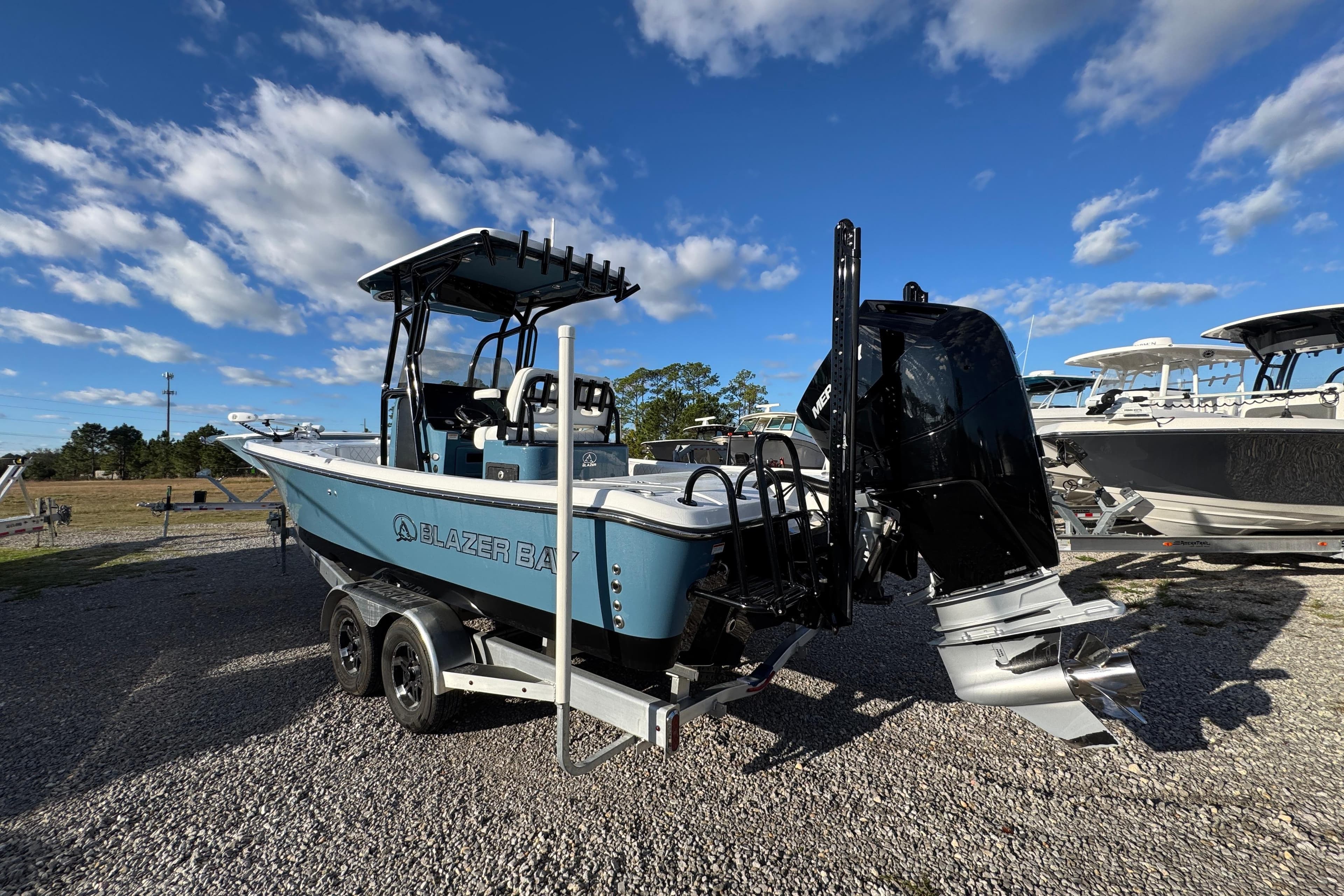2025 Blazer Bay 2700 Hybrid boat on trailer under blue sky.