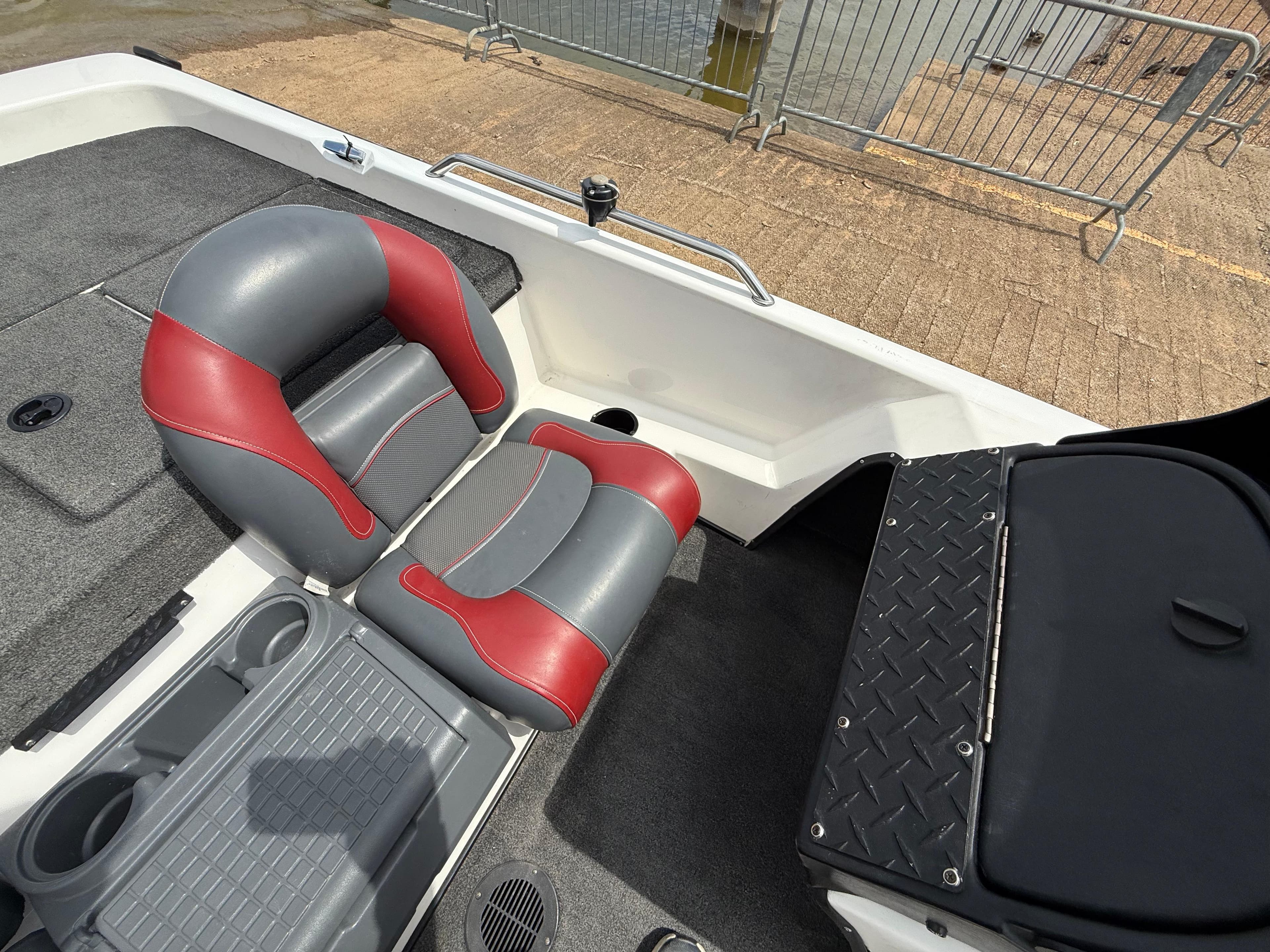 Interior of a 2003 Skeeter SX190 boat with gray and red seats.