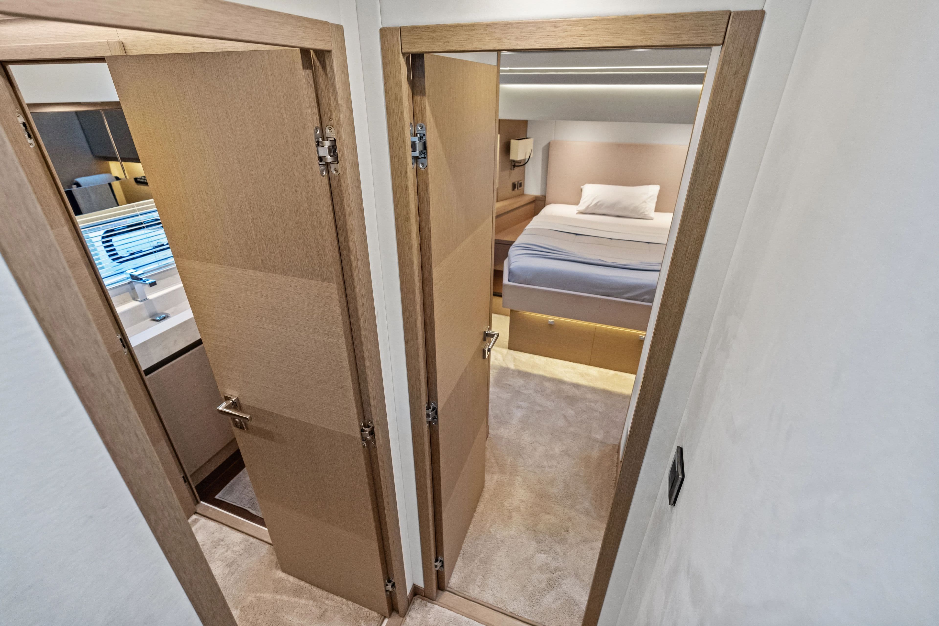 Interior of a 2018 Prestige 630 yacht, bedroom and bathroom view.