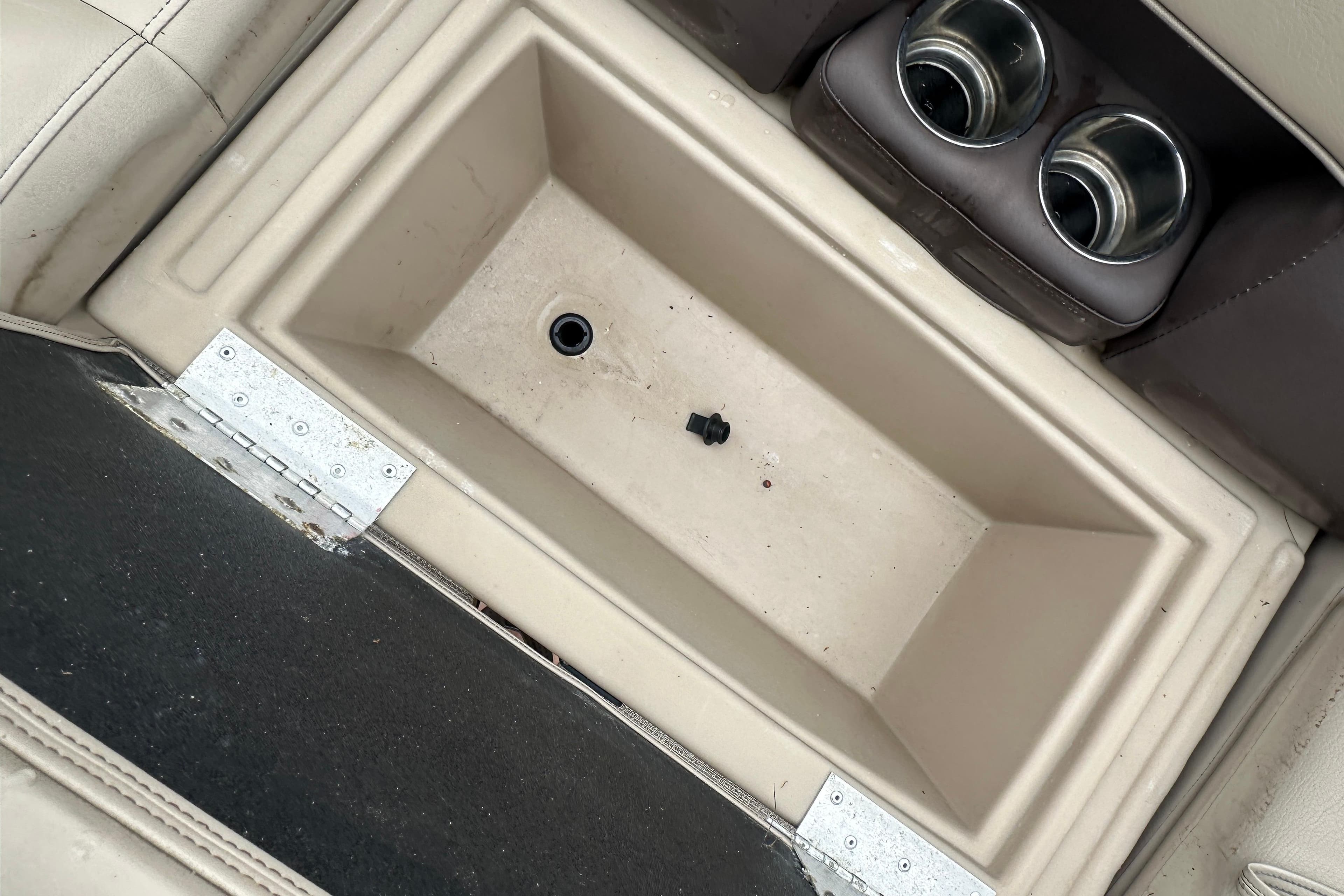 2021 Bentley Pontoons 240 CRUISE storage compartment with cup holders and beige interior.