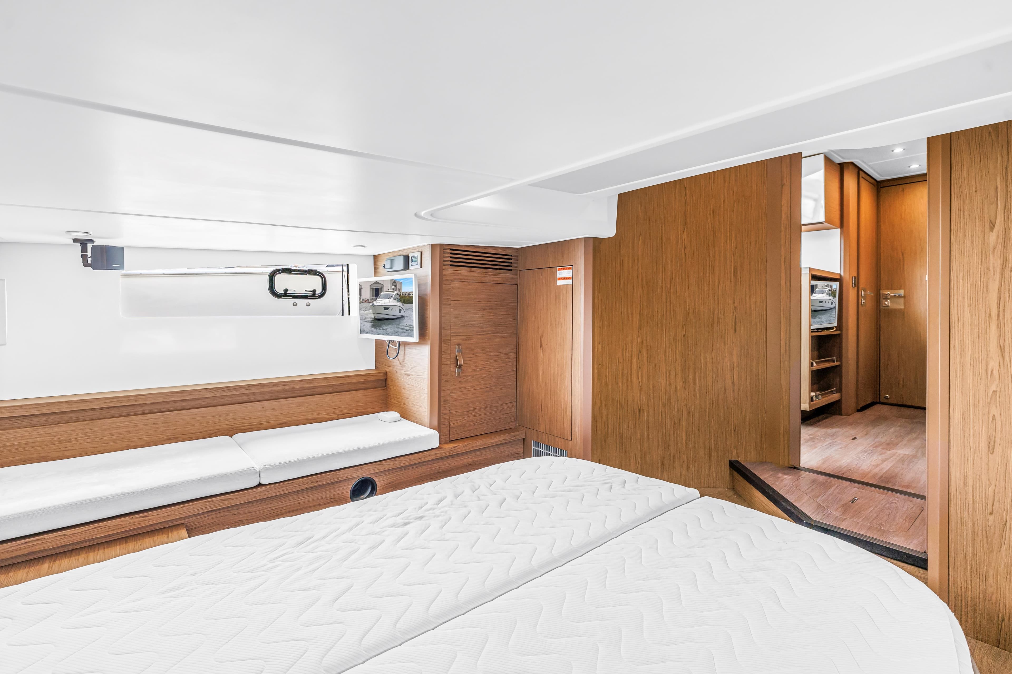 Luxurious interior of 2019 Beneteau Gran Turismo 46 yacht with modern wood finish.
