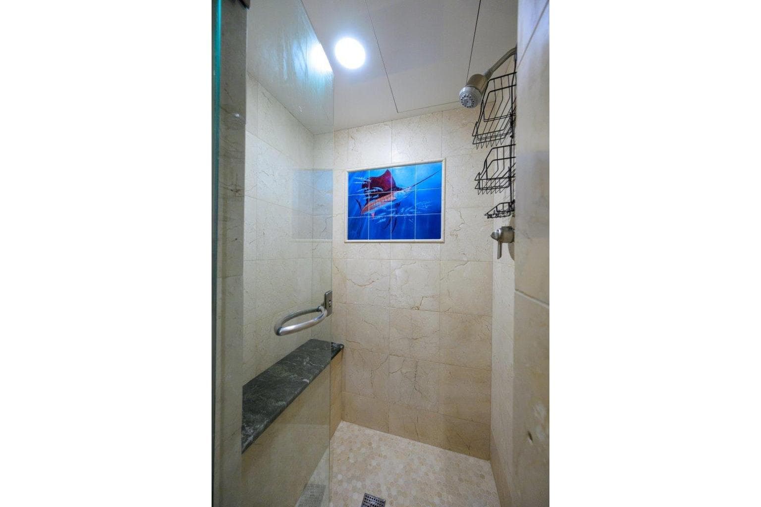 Luxurious shower in 2011 C & G Boatworks Explorer yacht, featuring elegant marble tiles.