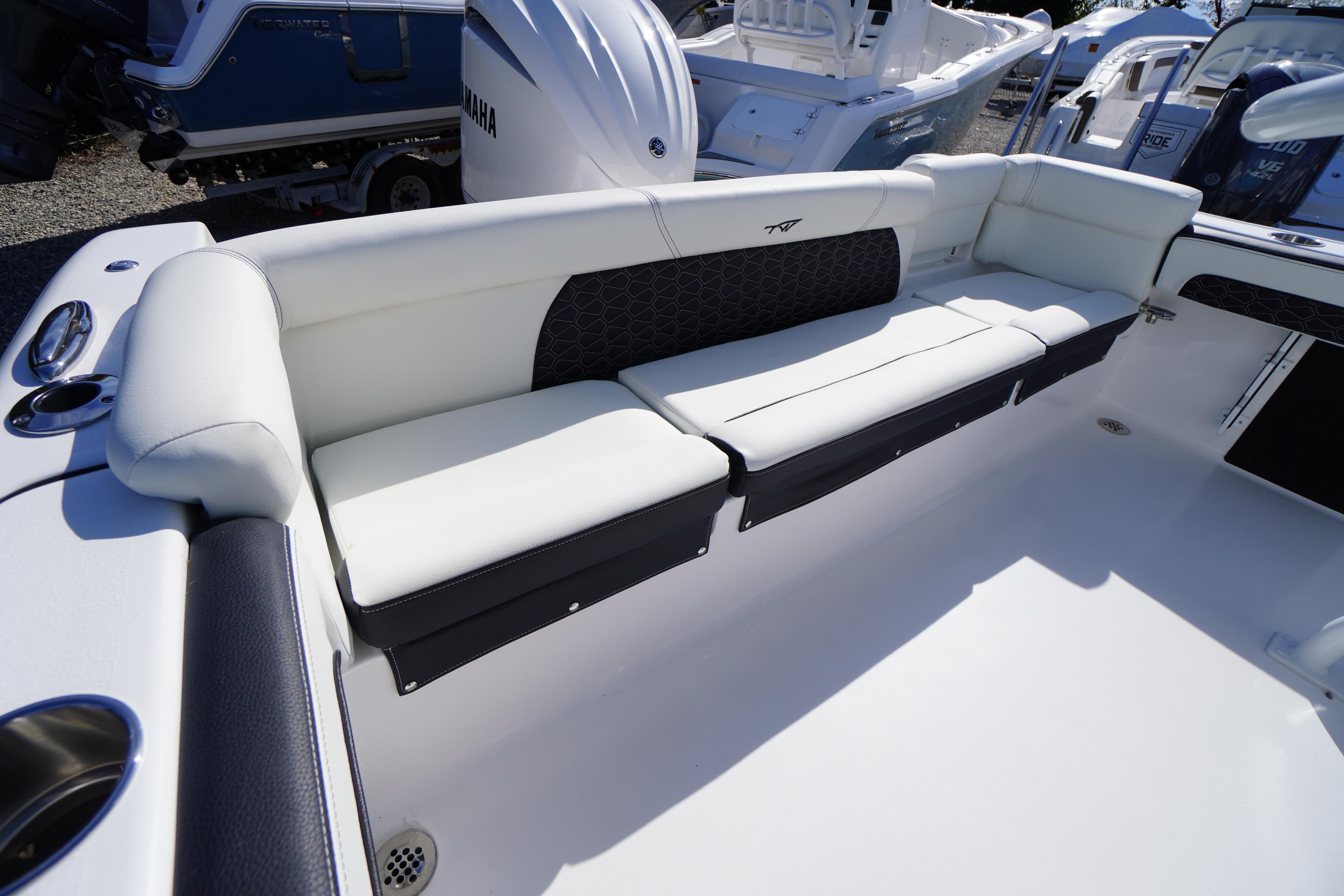2026 Tidewater 220 LXF boat interior with white cushioned seating and sleek design.