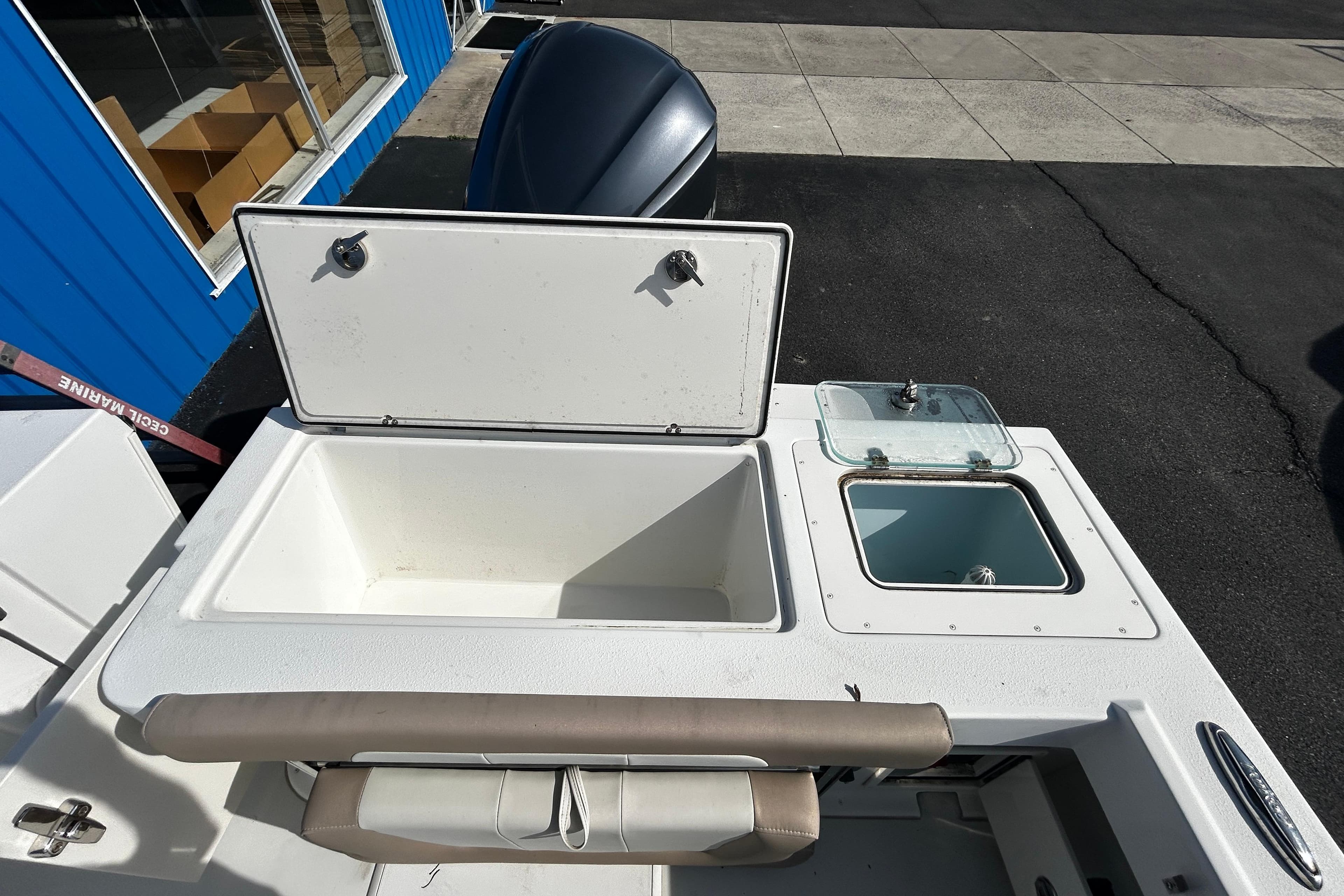 2019 Parker 2320 Sport Cabin boat with open storage compartments and seating.
