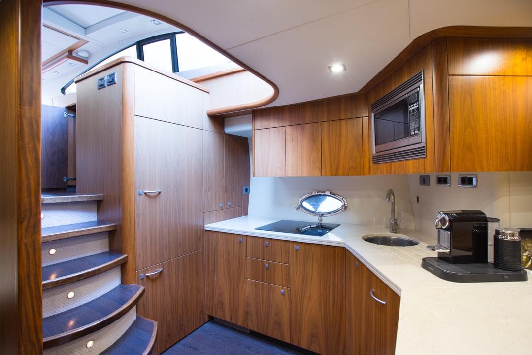 Luxurious interior of 2009 Sunseeker Predator 72 yacht with modern kitchen design.