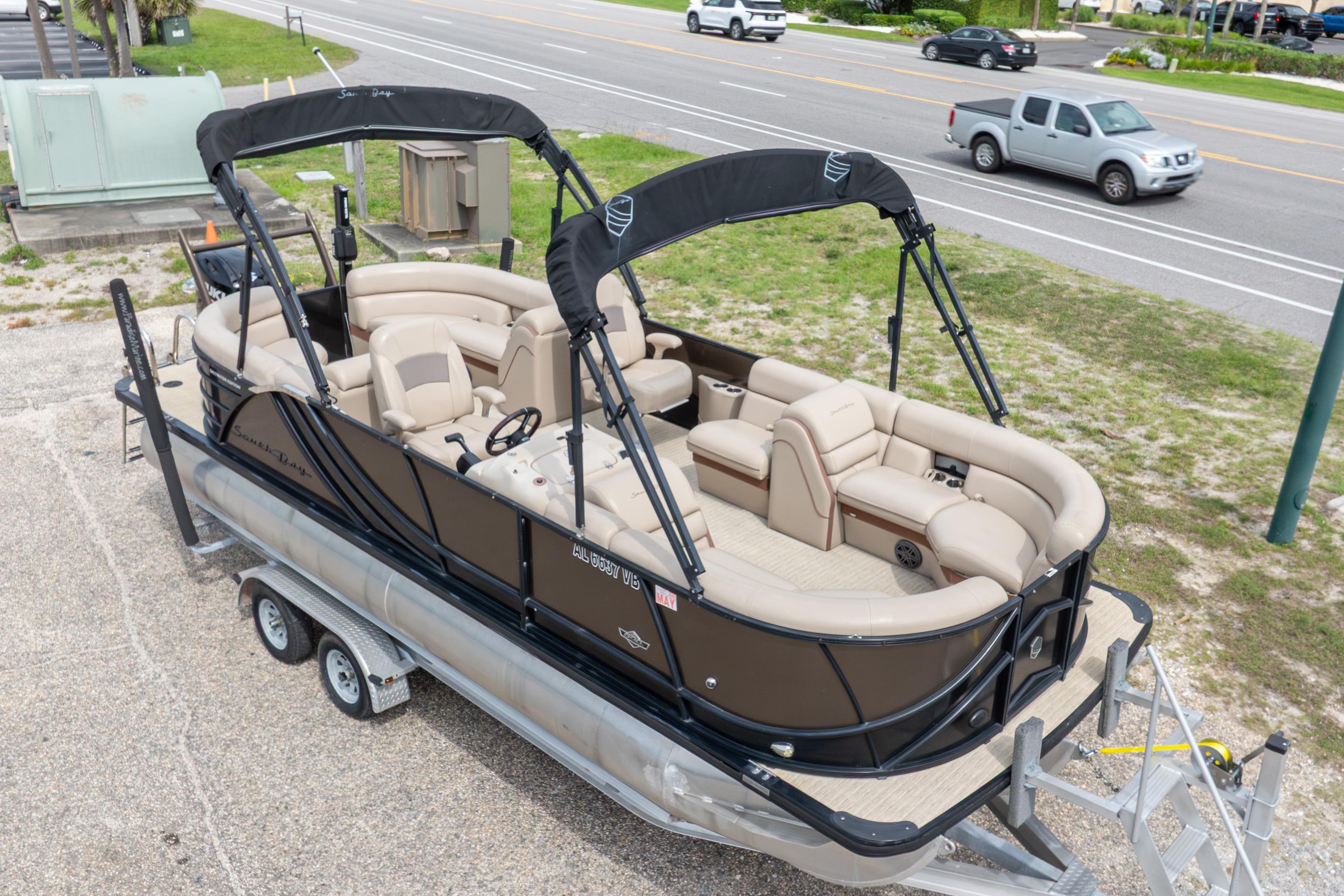 2018 South Bay 523RS pontoon boat on trailer, parked near a road.