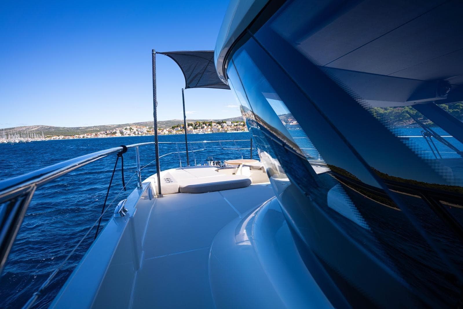 Luxury Prestige X60 yacht cruising on blue ocean, 2023 model.