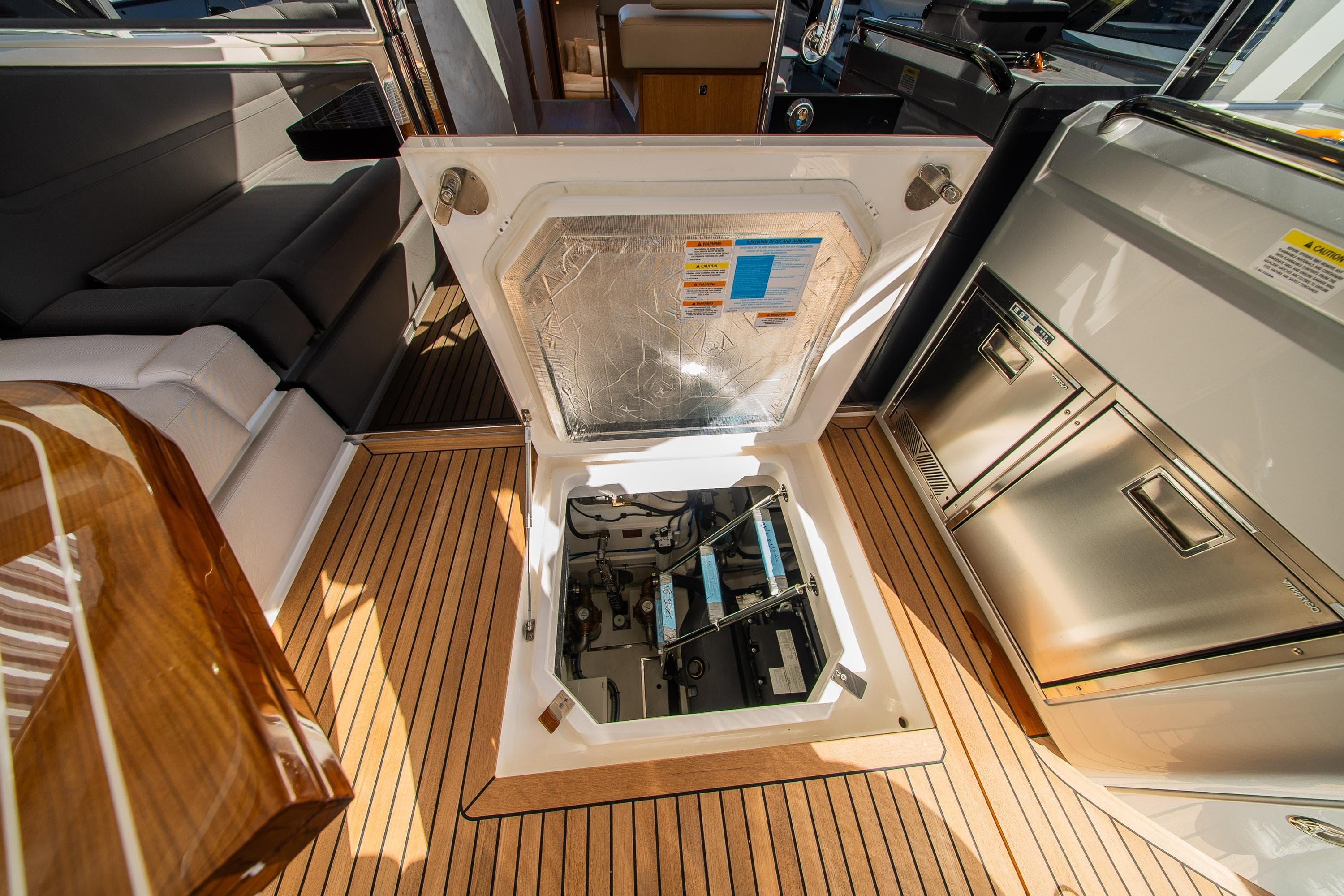 Open hatch on 2026 Riviera 4600 Sport Yacht Platinum Edition, showcasing engine compartment.