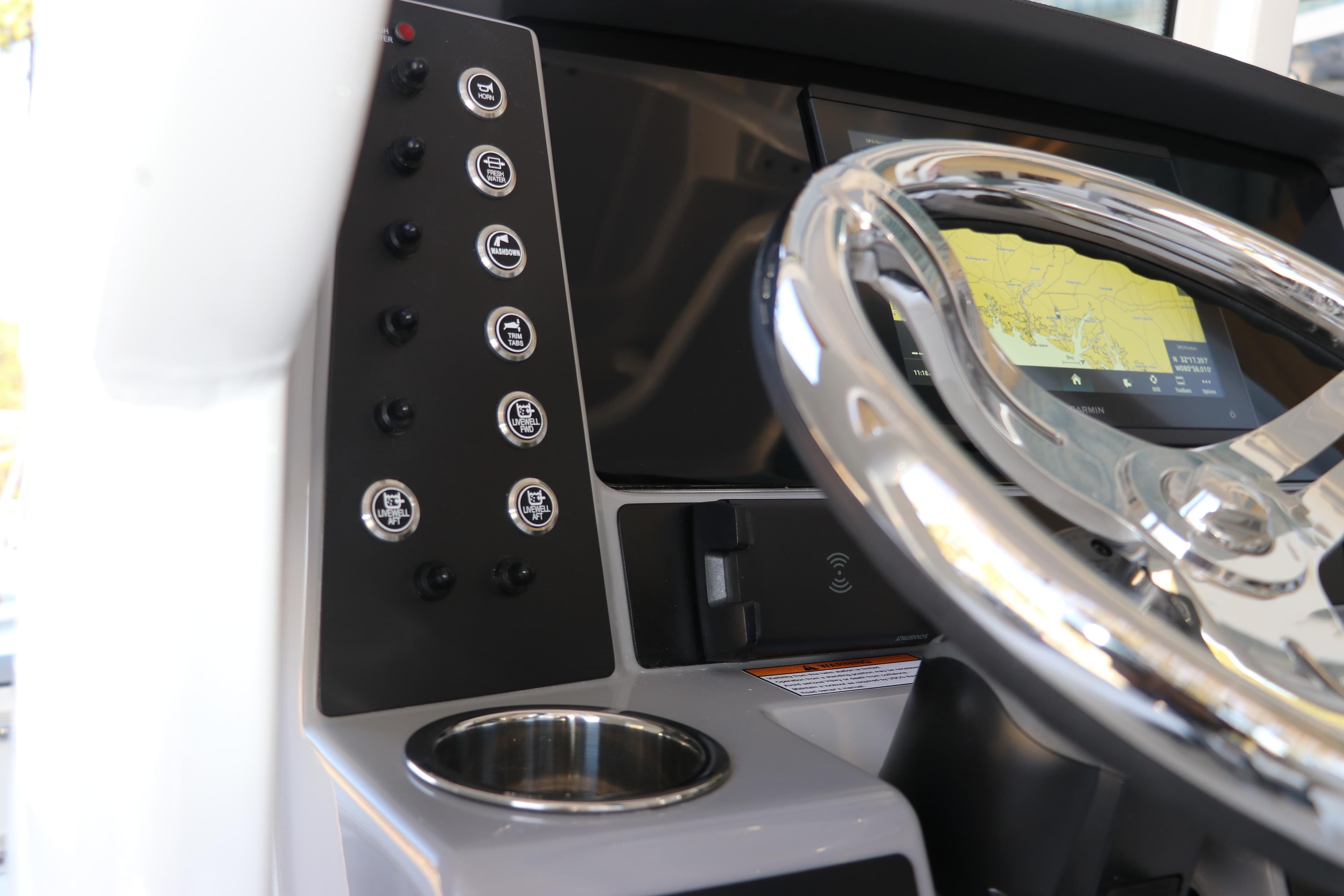 2026 Robalo 246 Cayman boat dashboard with steering wheel and navigation display.