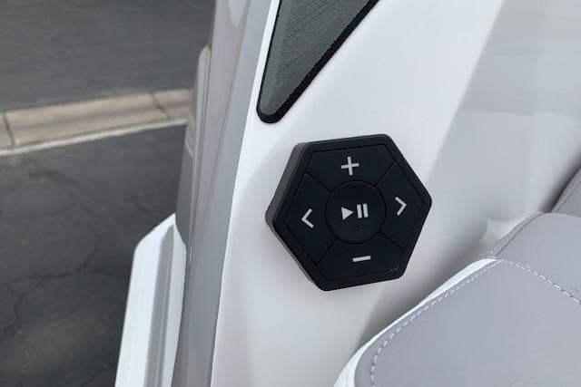 Hexagonal control panel on 2026 Supra SA 450 boat, featuring playback and volume buttons.