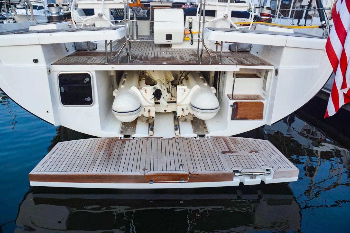 Hanse 675 yacht stern view with open garage, 2018 model, docked in marina.