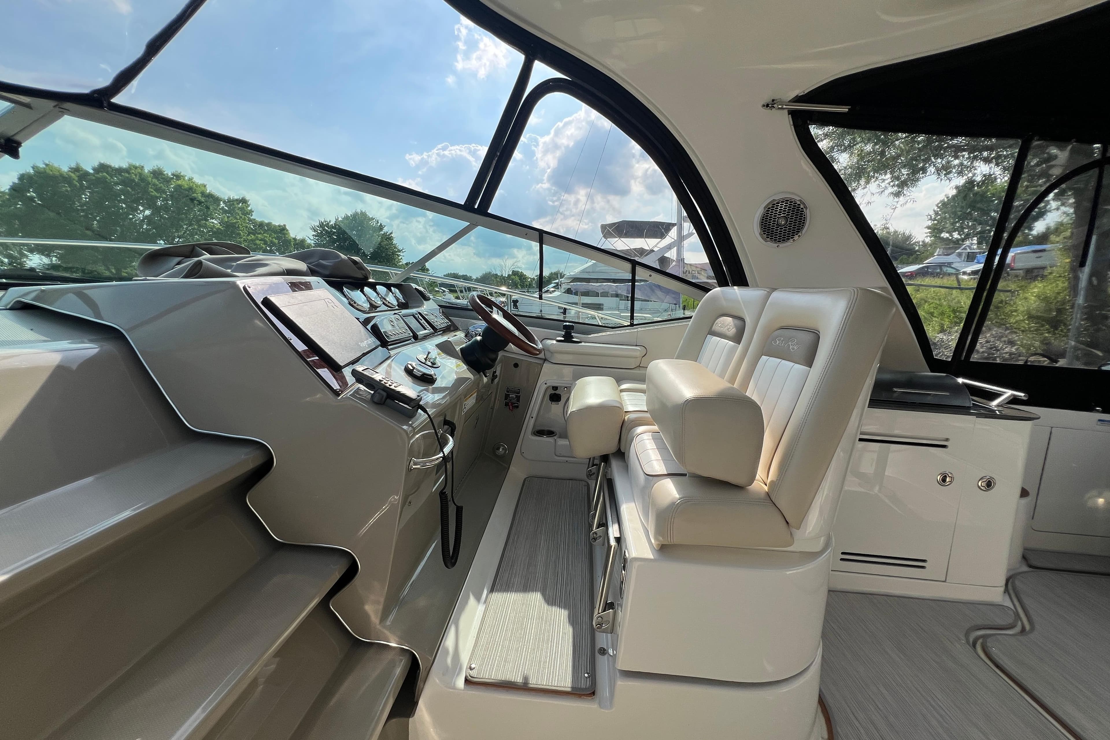 Interior cockpit of 2012 Sea Ray 370 Sundancer with modern controls and seating.