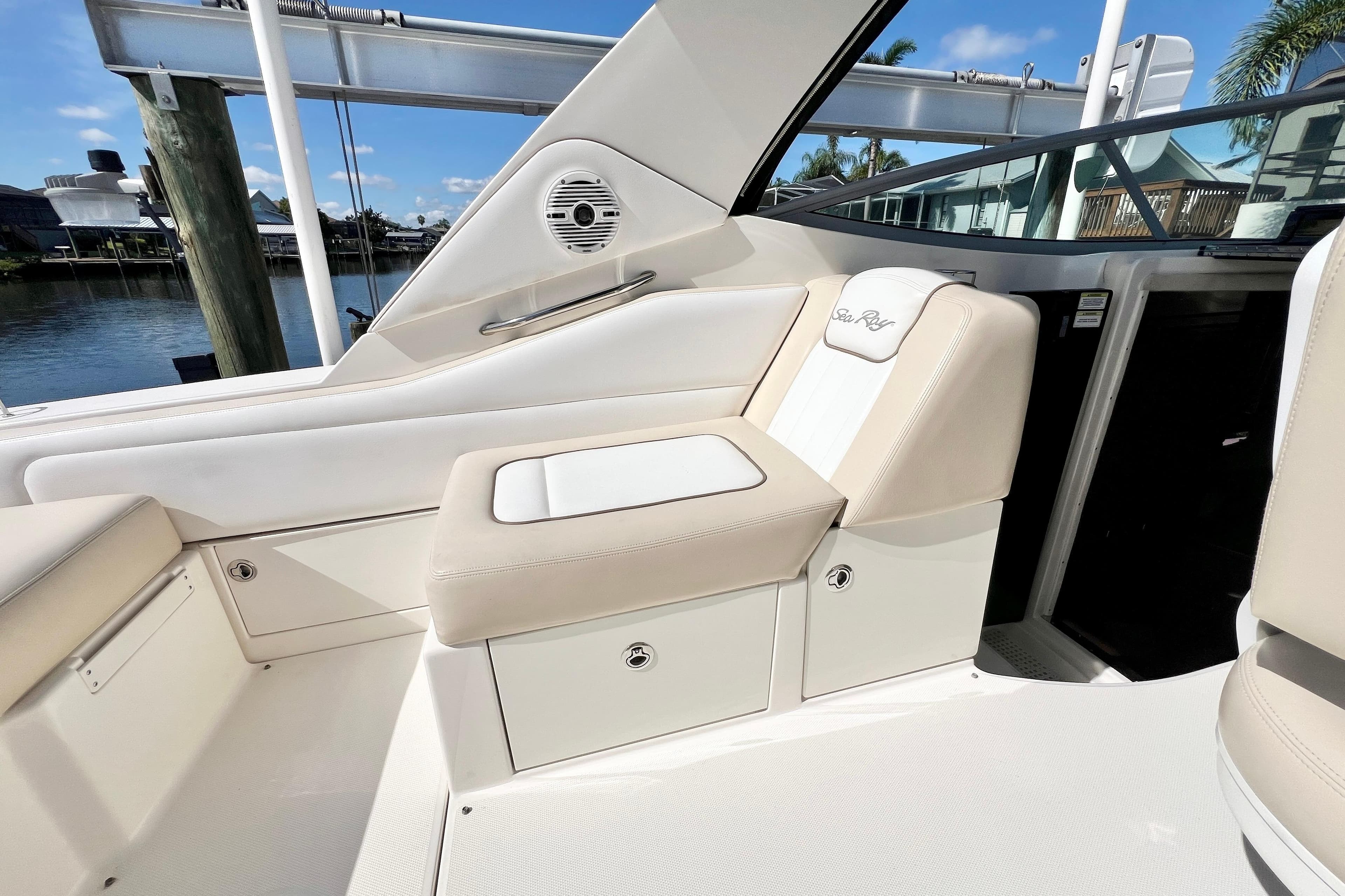 2012 Sea Ray 310 Sundancer boat interior with beige seating and storage compartments.
