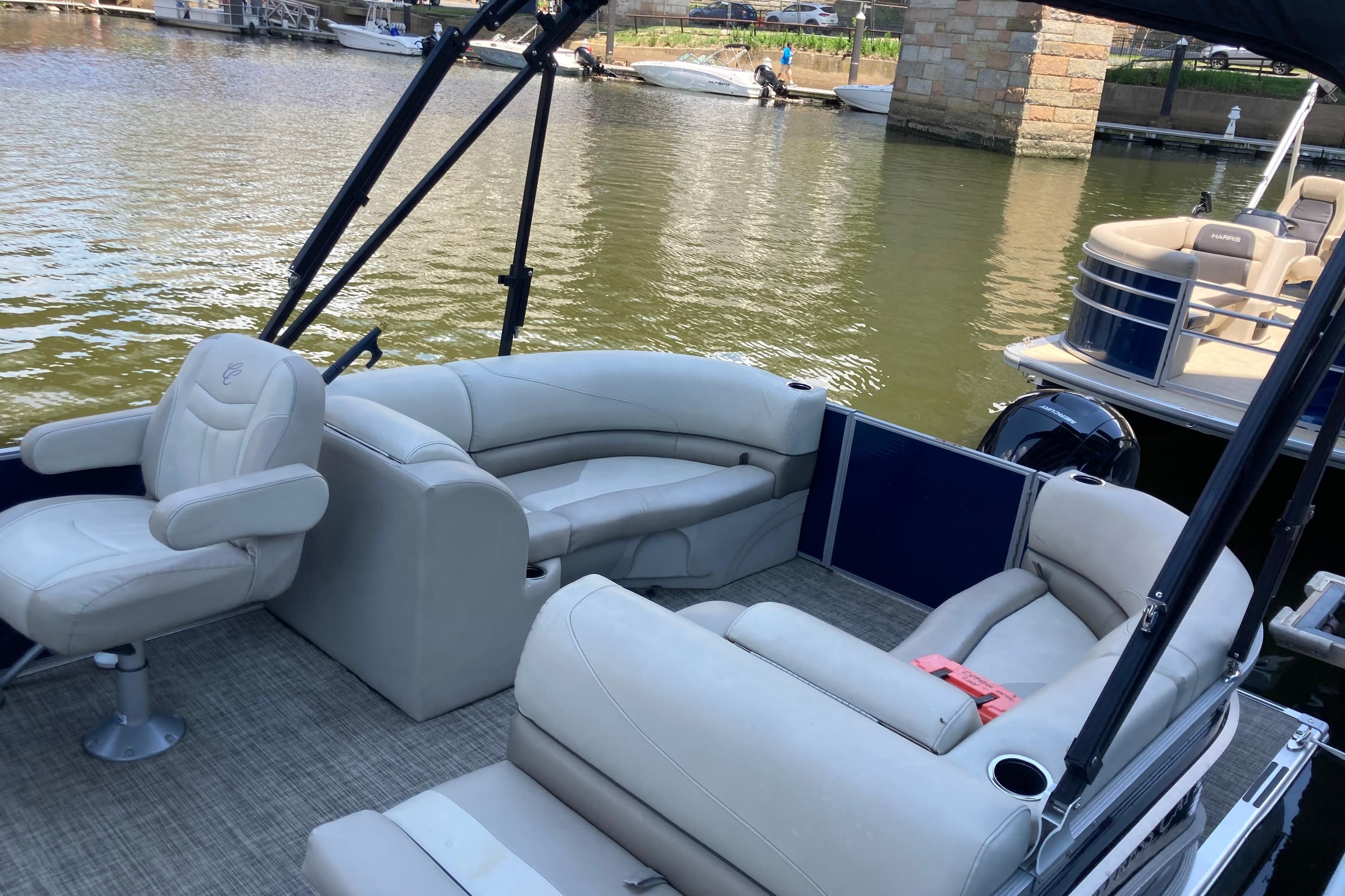 2023 Cypress Cay Seabreeze 232 pontoon boat with spacious seating and scenic water view.