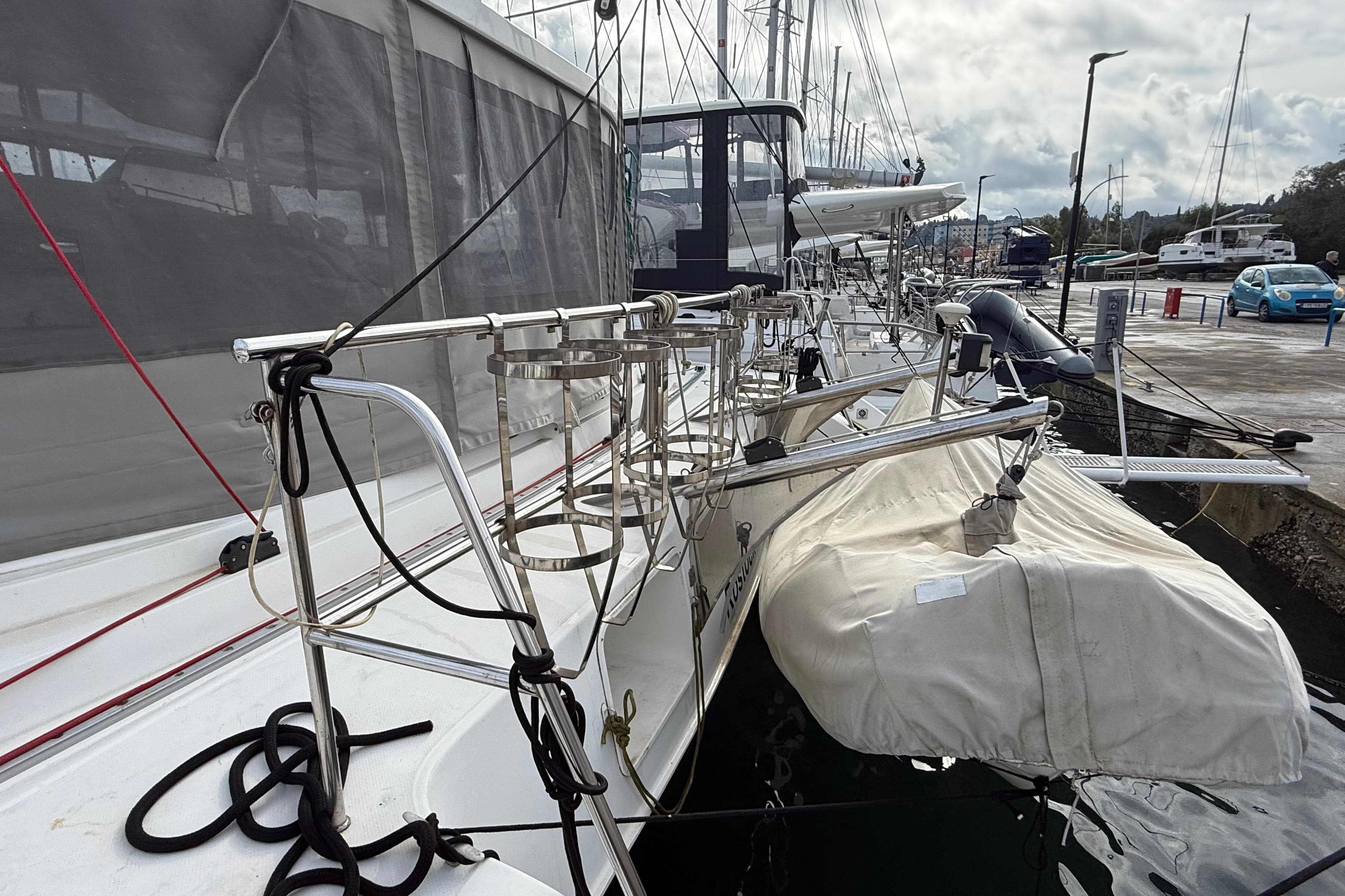 2003 Fountaine Pajot Belize 43 catamaran docked, featuring deck details and mooring lines.
