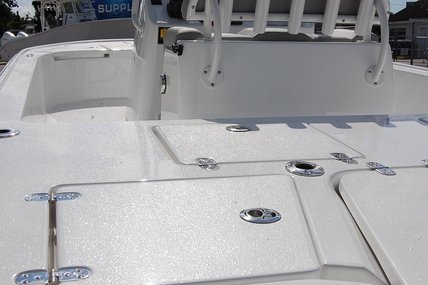 2026 Cape Horn 23 Cape Bay boat deck with storage compartments and seating.