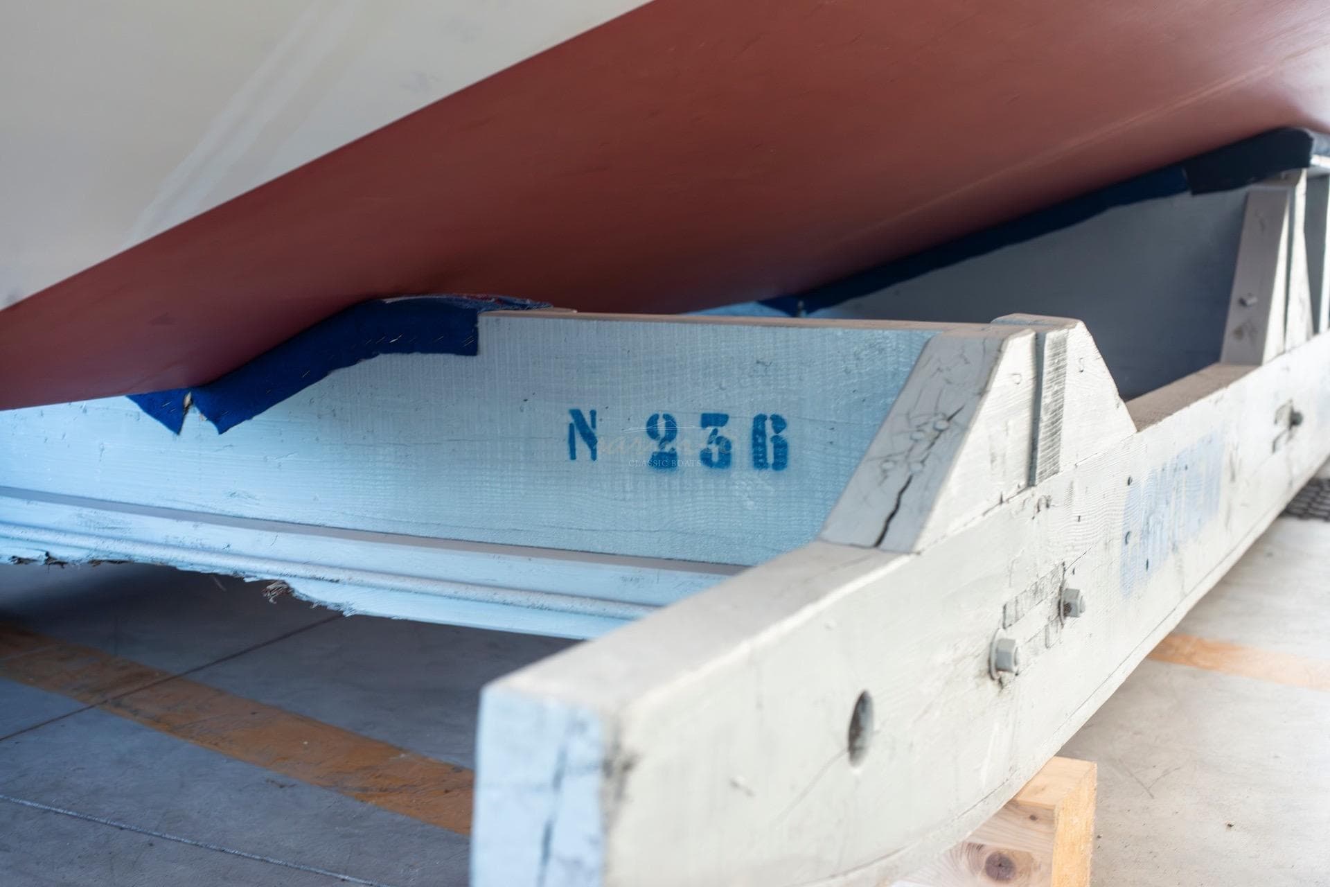 1967 Riva Aquarama boat hull on wooden support with number N 256 visible.