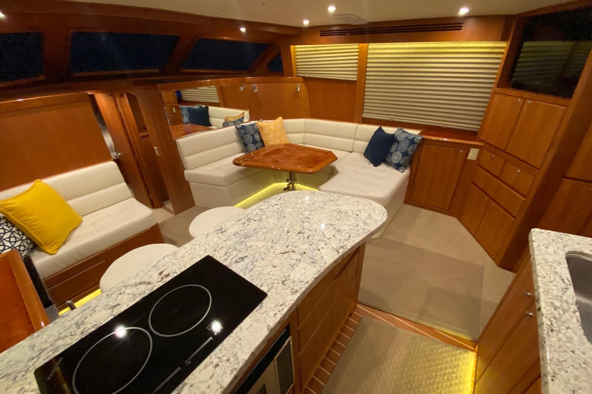 Luxurious interior of 2026 Mikelson 45 Gen III Sportfish yacht with modern seating and kitchen.