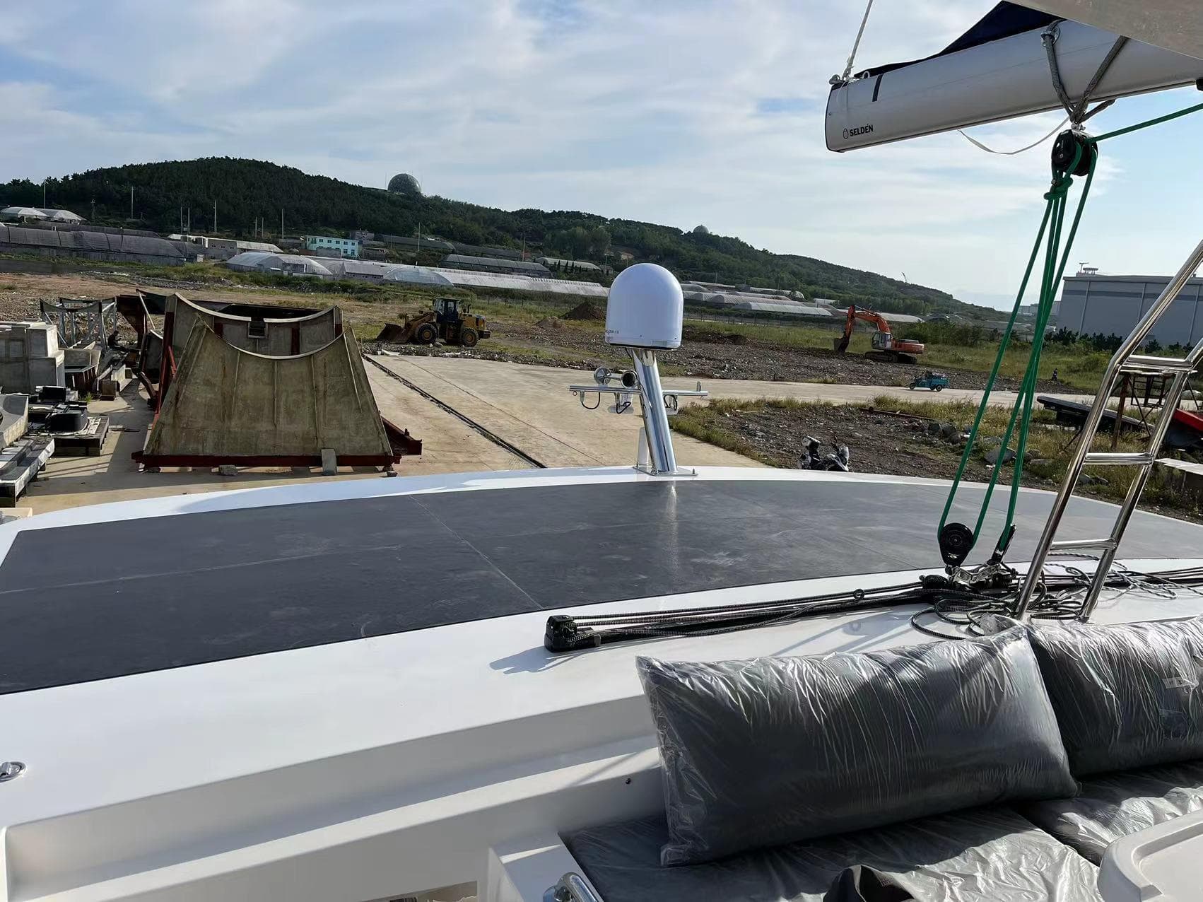 Mazarin 55 Catamaran 2023 with sun deck and cushions, docked at harbor.