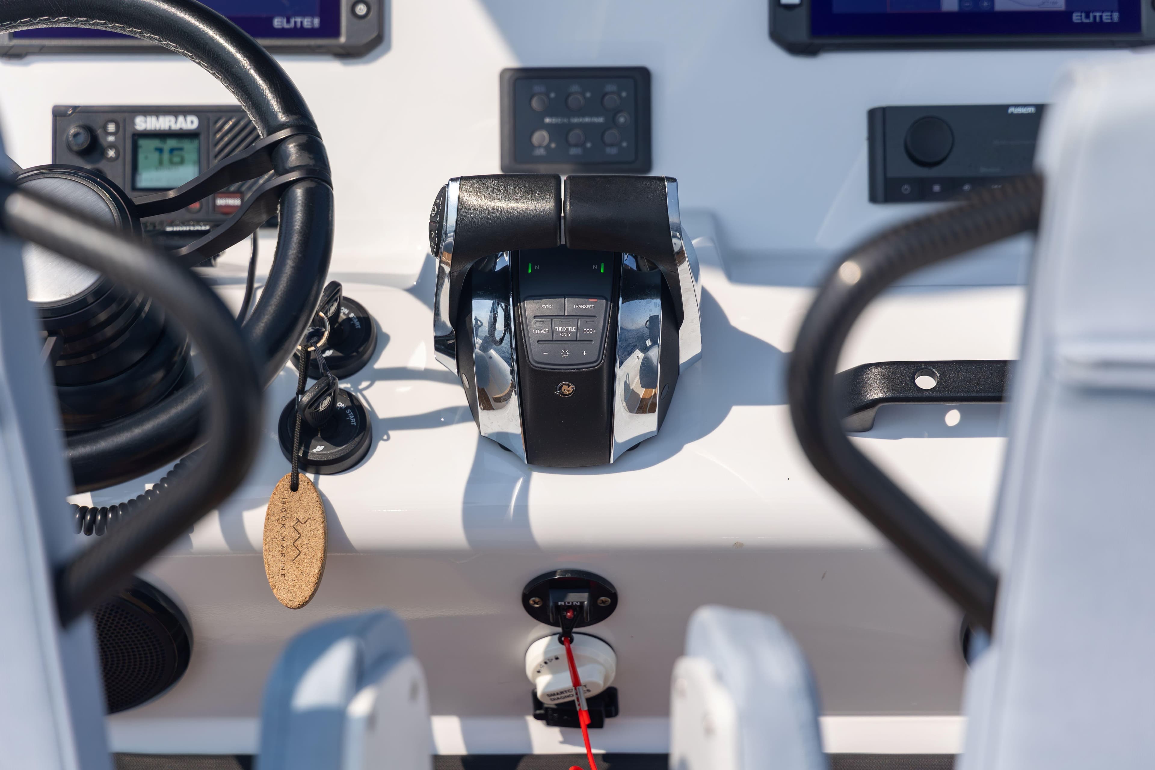 Control panel of 2026 Rock Marine RM 30 boat with steering wheel and throttle.