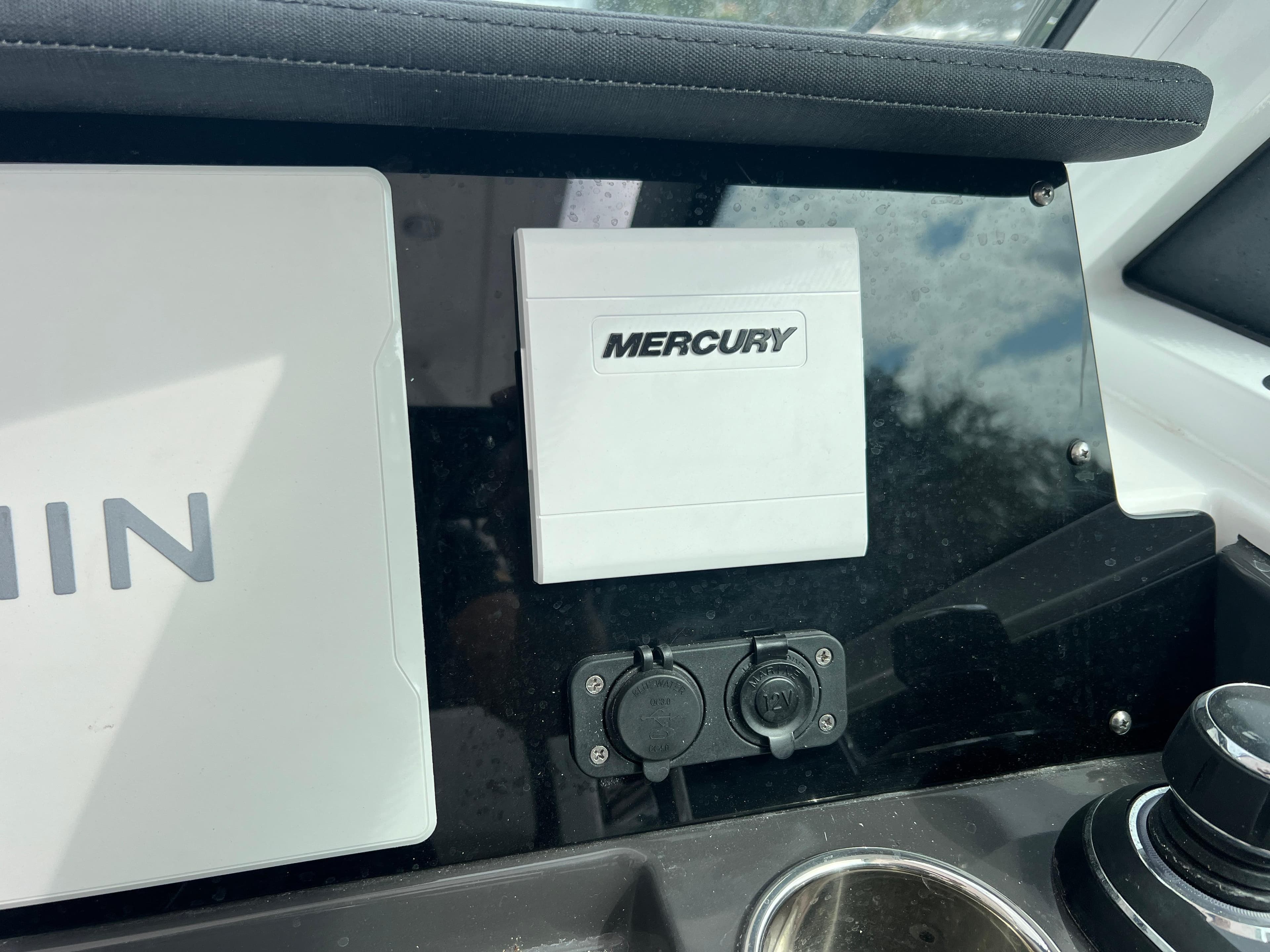 2024 Blackfin 272 DC dashboard featuring Mercury controls and dual power outlets.