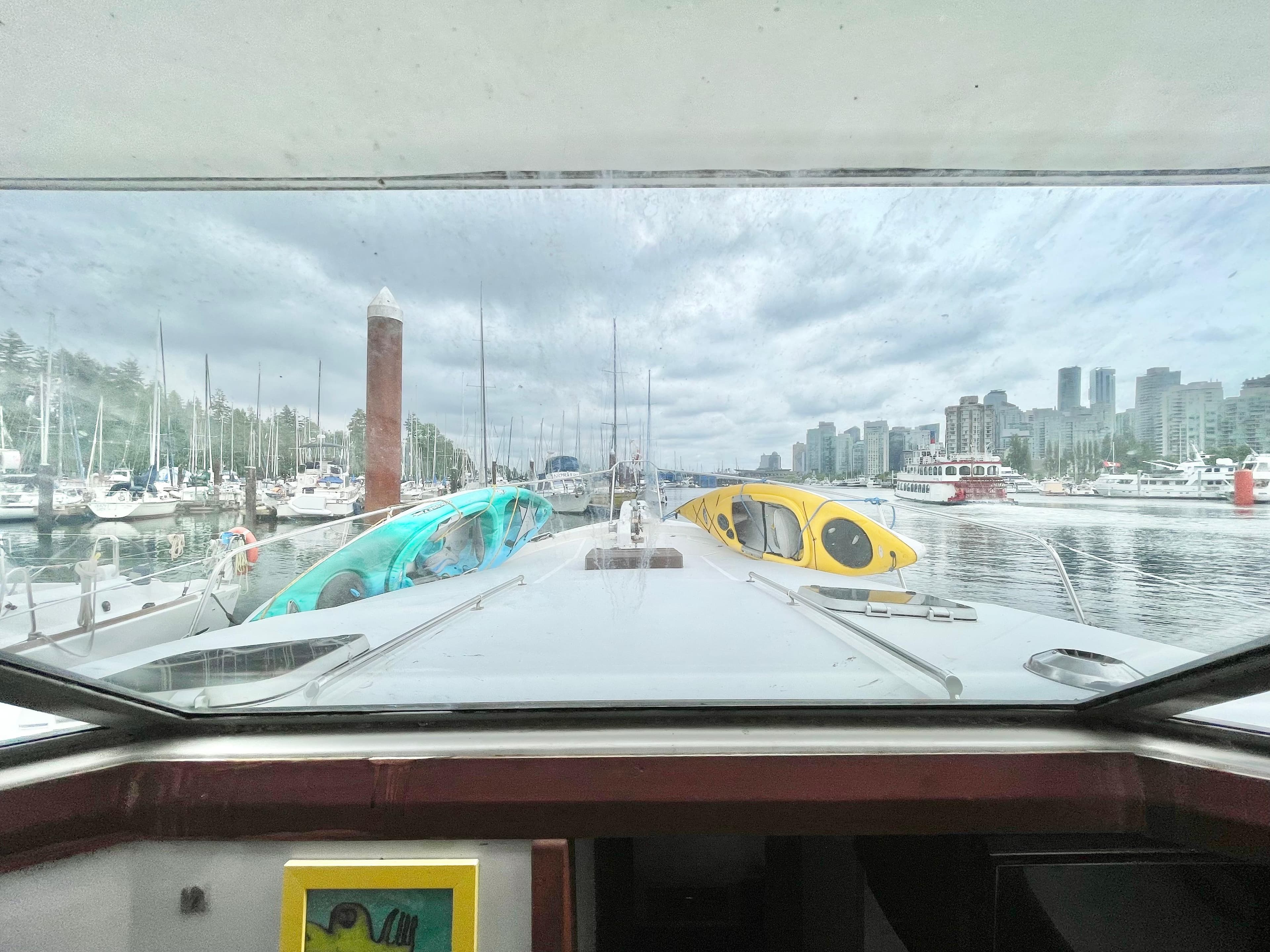View from 1987 Bayliner 3870 Motoryacht, showcasing marina and city skyline.