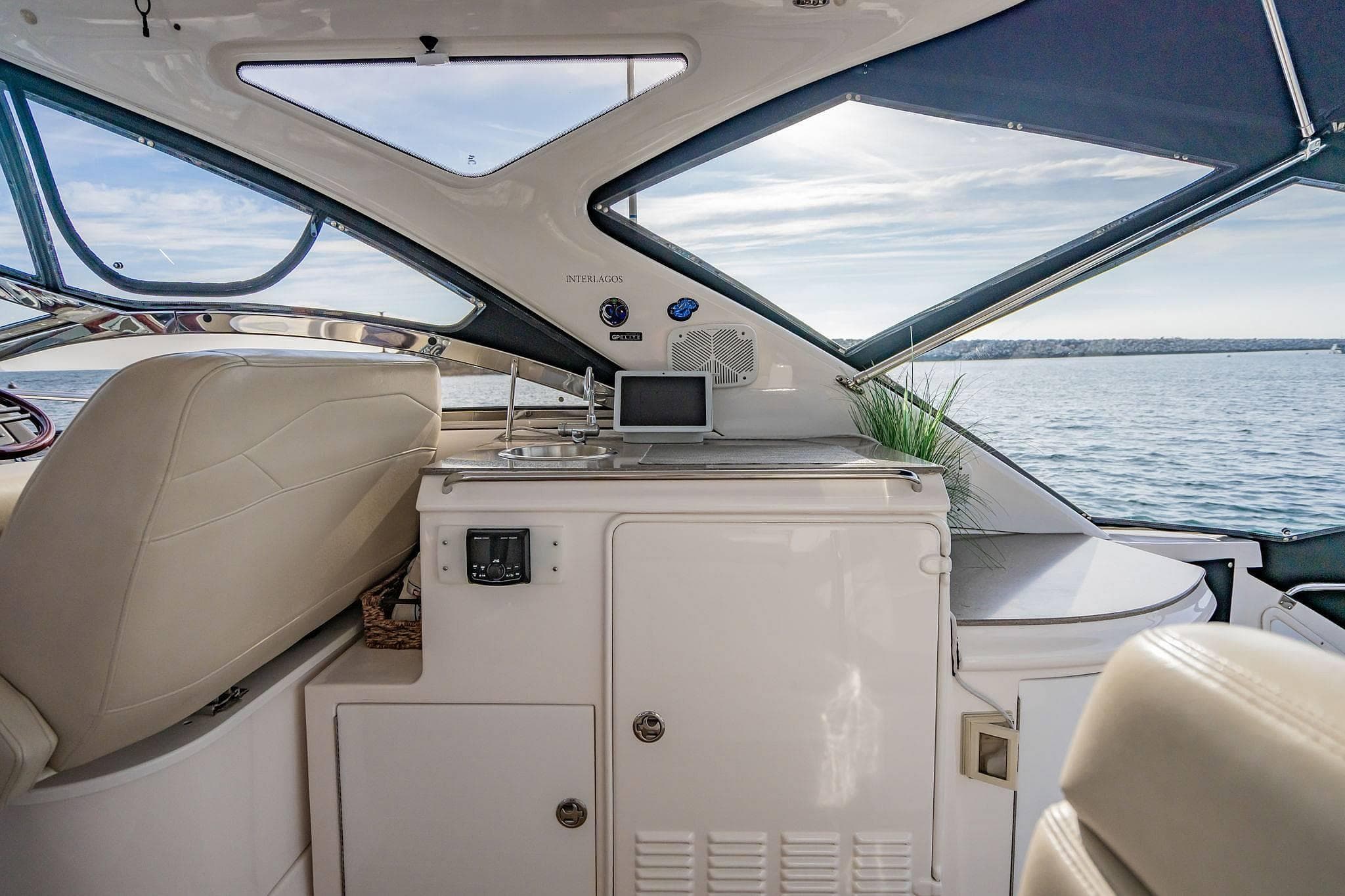 Interior view of a 2010 Regal Commodore 4460 yacht with luxurious seating and ocean backdrop.