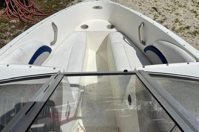 2005 Stingray 180 RX boat interior with white seating and blue accents.