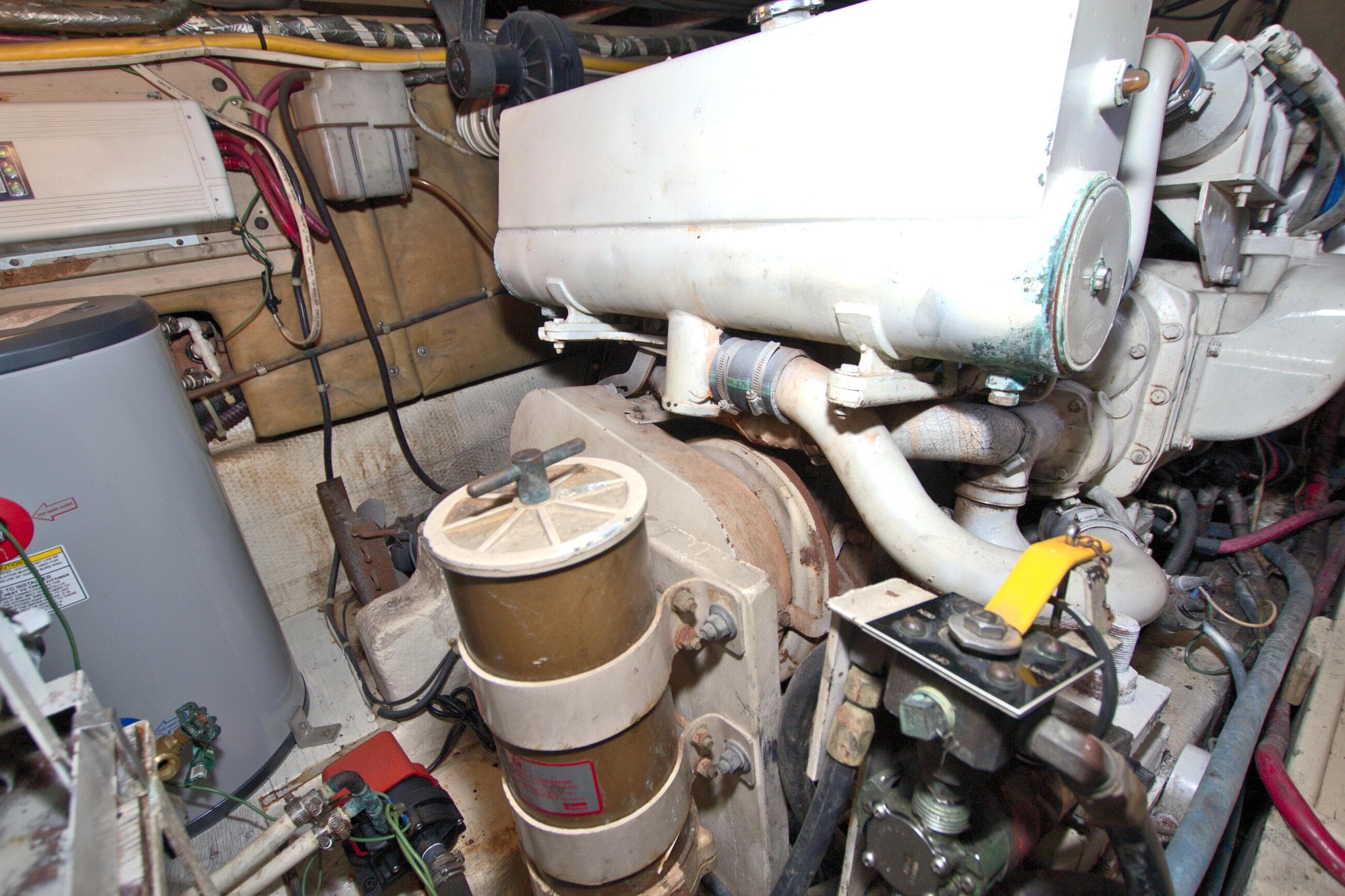 Engine room of a 1990 Post 44 Sport Fisherman boat, showcasing mechanical components.