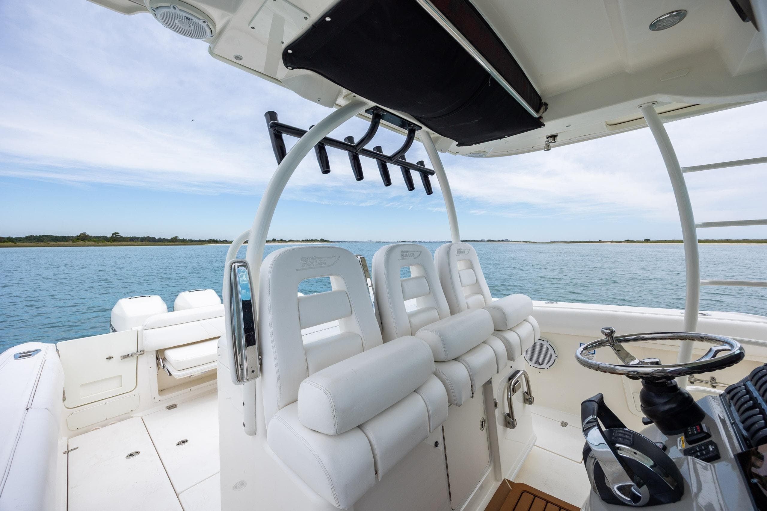 2017 Boston Whaler 370 Outrage boat interior with helm and seating on open water.
