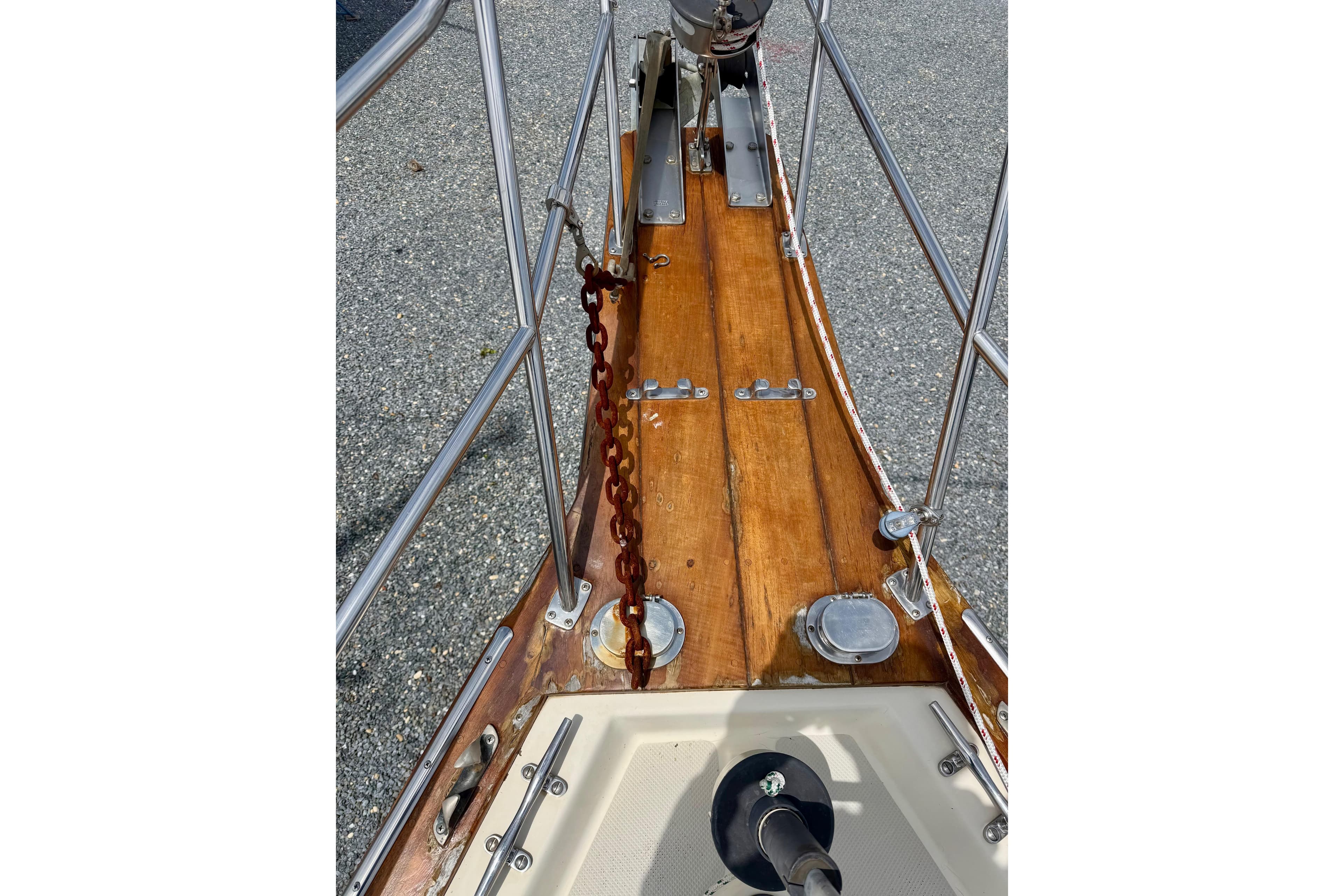 Bow of 1992 Island Packet 29 sailboat with wooden deck and anchor chain.