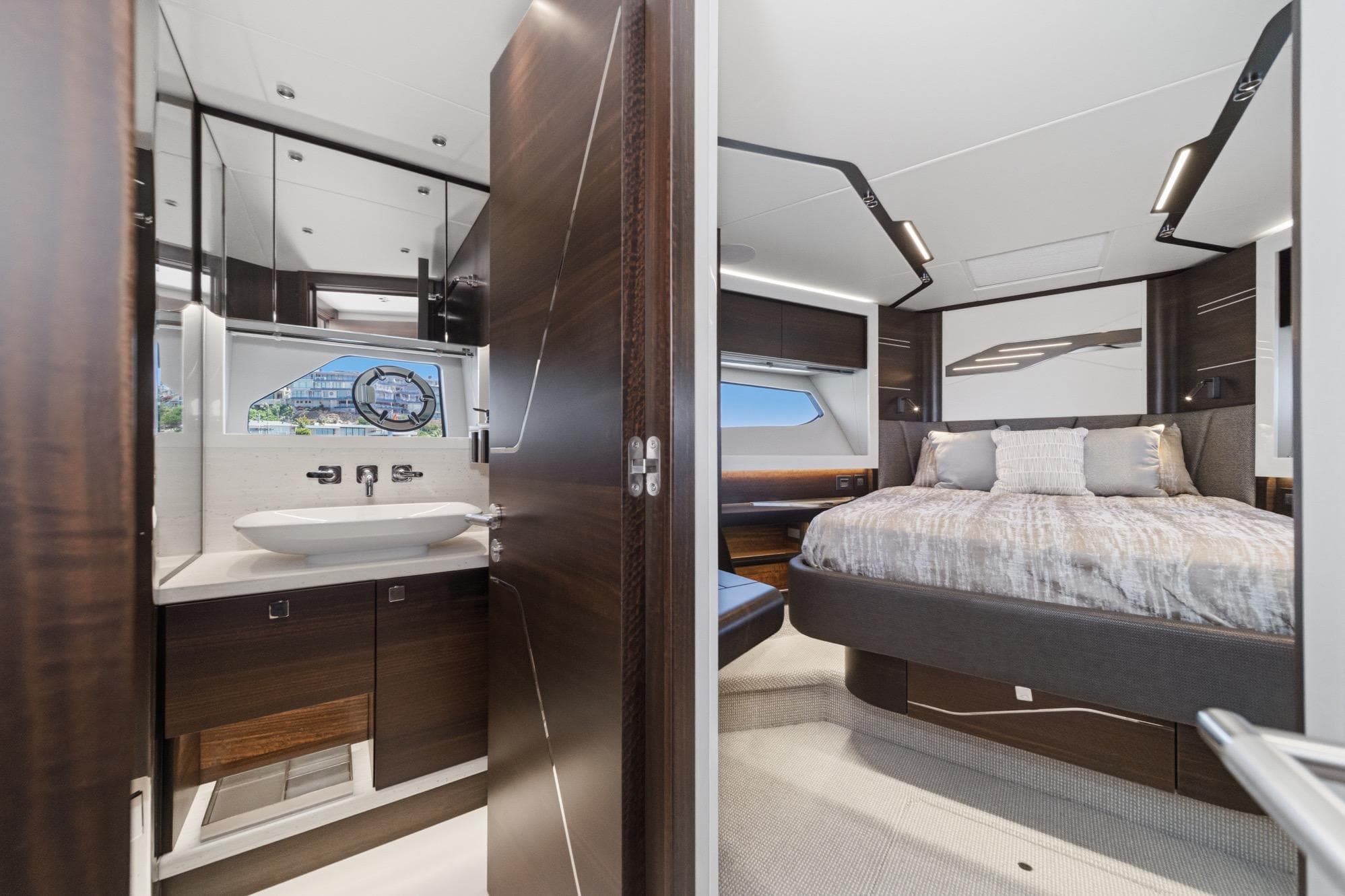 Luxurious interior of 2023 Sunseeker 65 Sport Yacht featuring bedroom and bathroom.