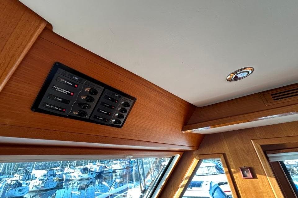 Control panel inside 2008 Grand Banks 59 Aleutian RP yacht with wood interior.