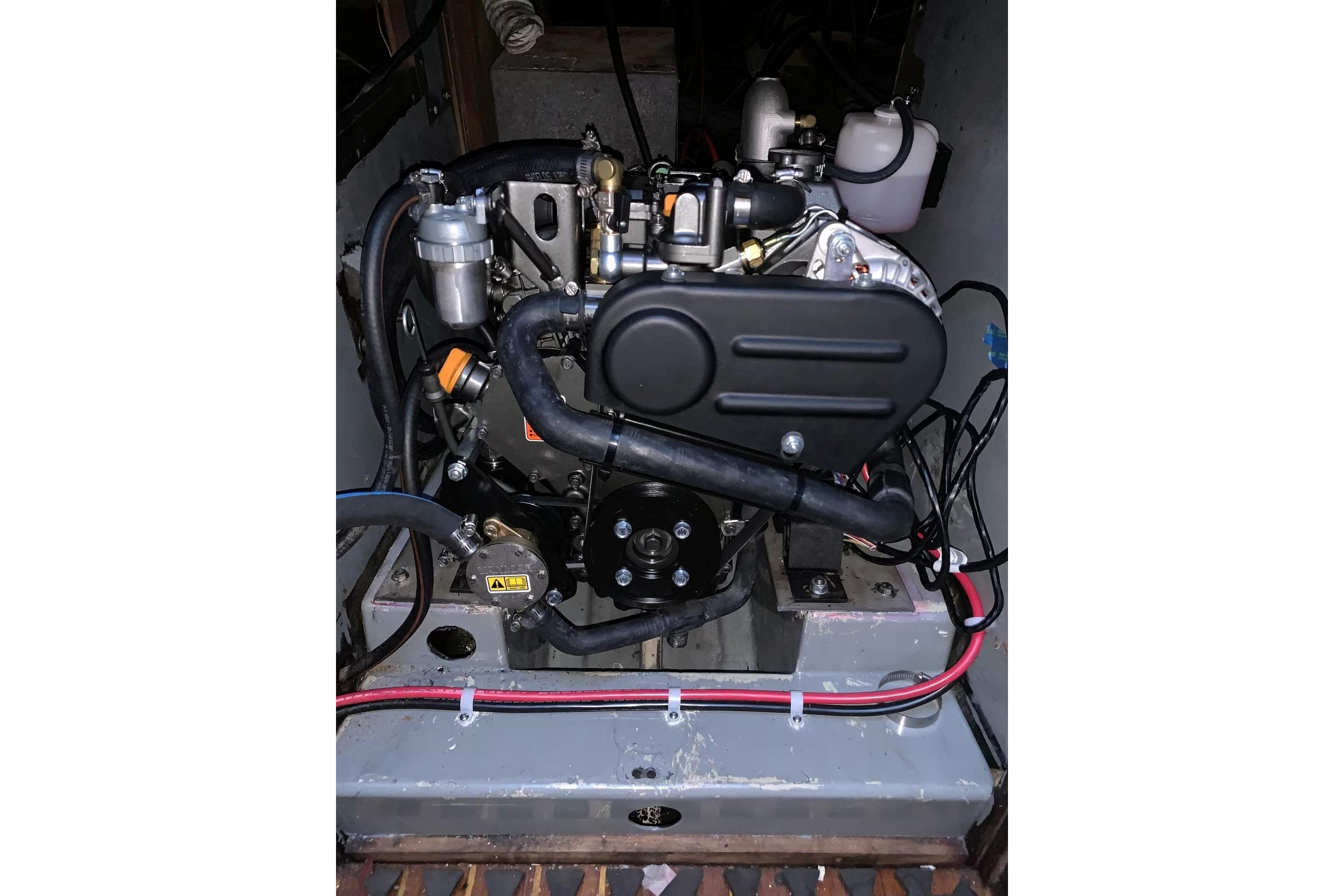Engine compartment of a 1981 Ericson 36RH sailboat, showcasing mechanical components and wiring.