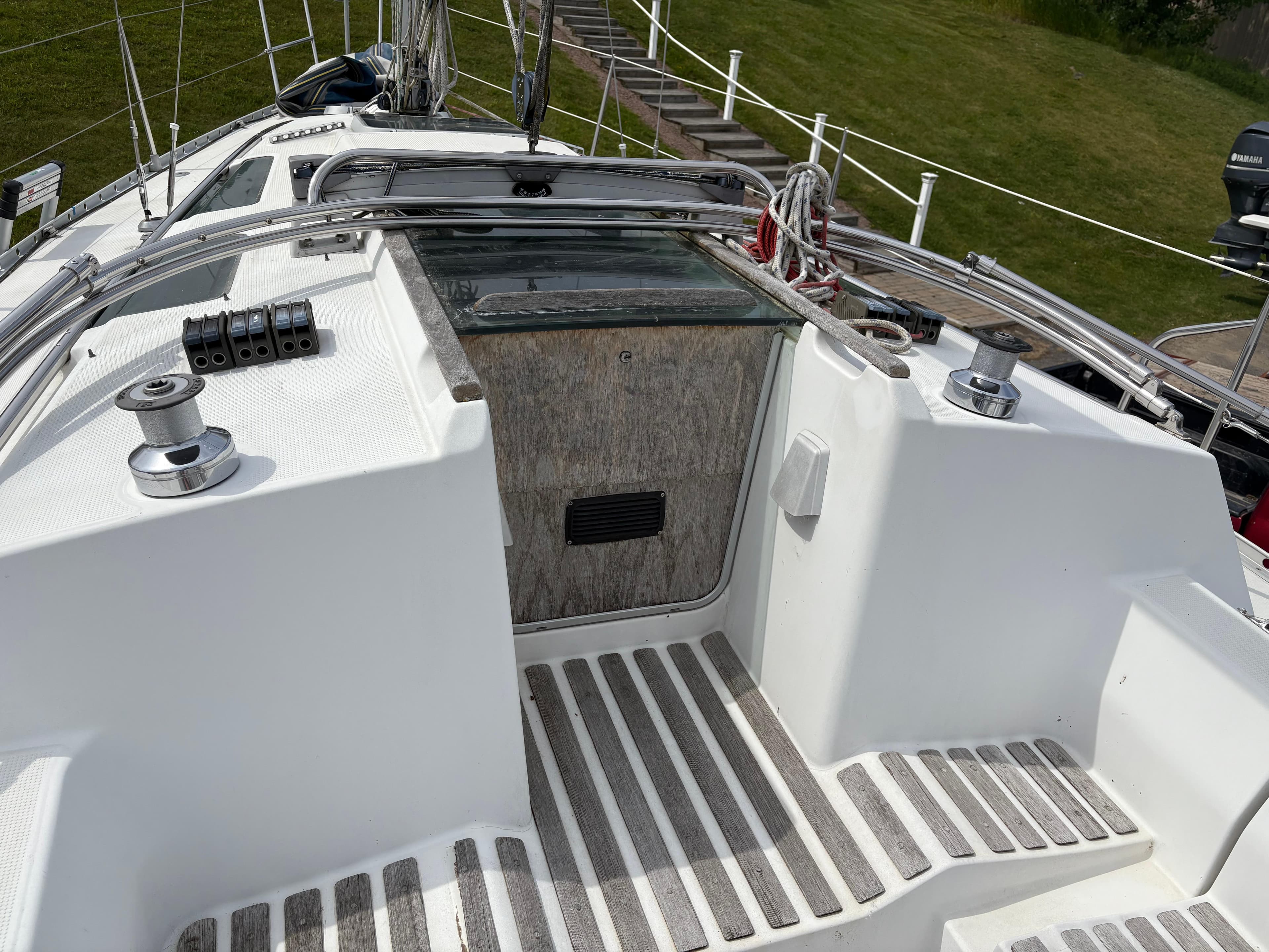 Cockpit of 1989 Beneteau 32s5 sailboat with winches and teak flooring.