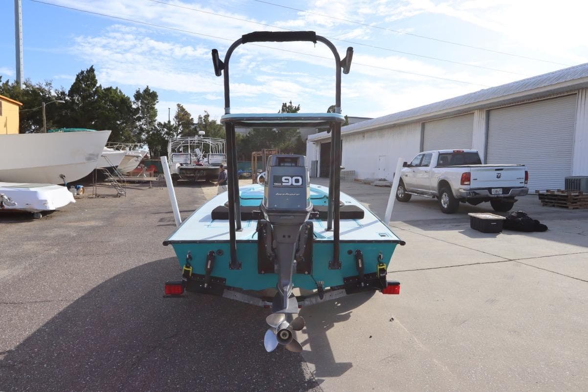 1996 Silver King Signature 16 boat with outboard motor in a marina setting.