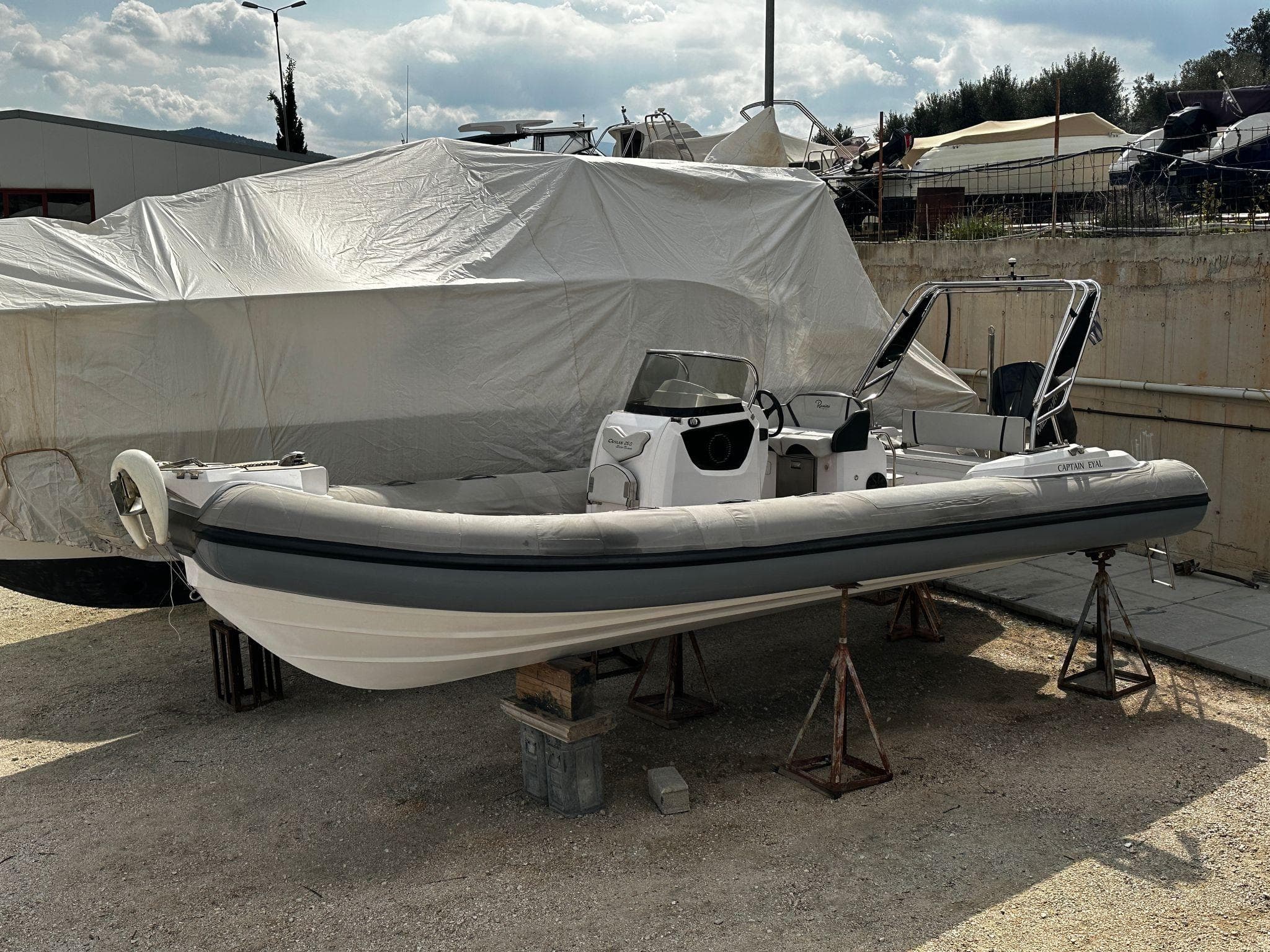 2021 Ranieri Cayman 26 inflatable boat on stands, outdoor storage setting.