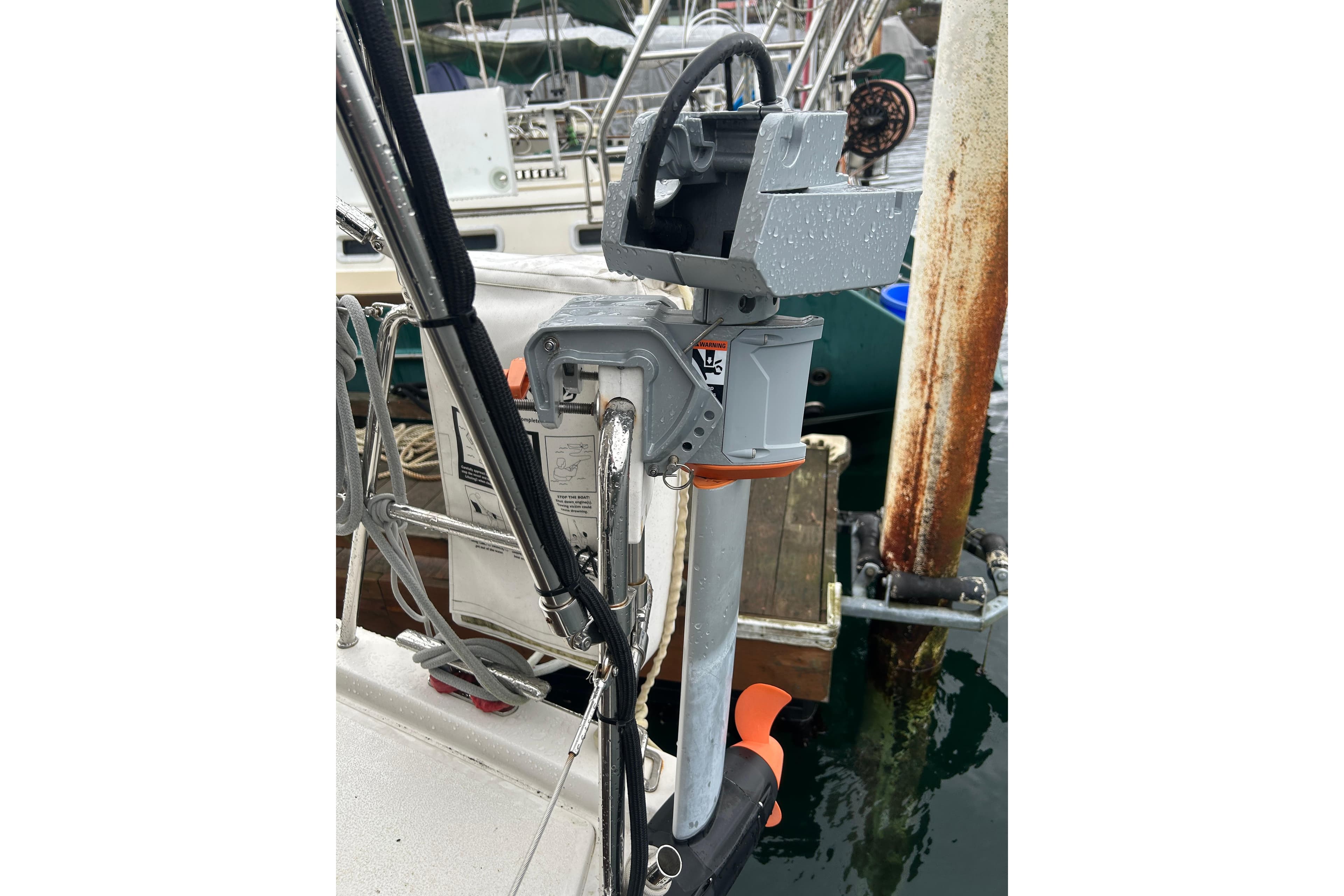 Close-up of a 2019 X-Yachts X4³ sailboat's outboard motor at a marina.