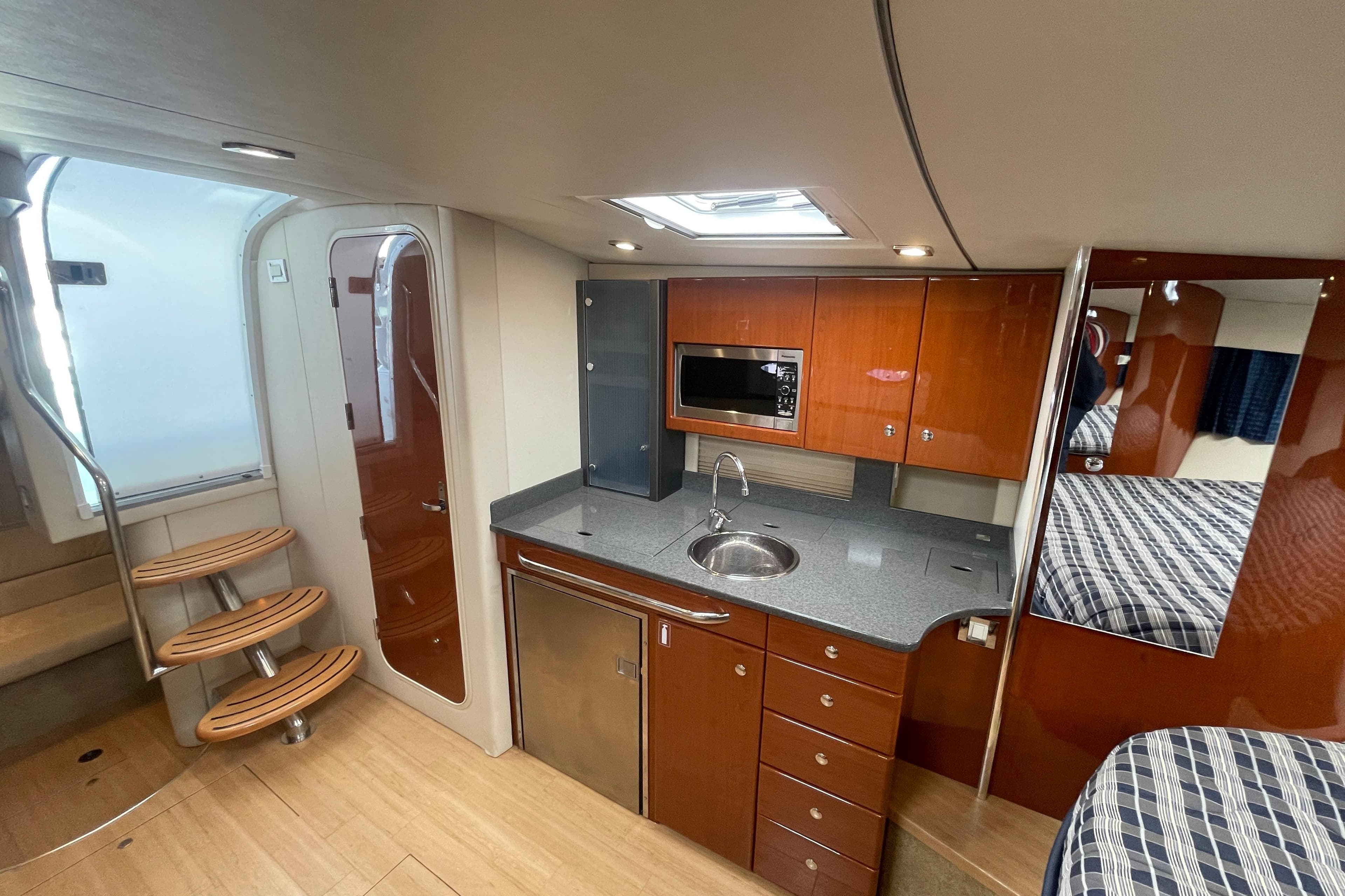 Interior of 2011 Formula 34 Performance Cruiser with modern kitchen and wooden cabinetry.