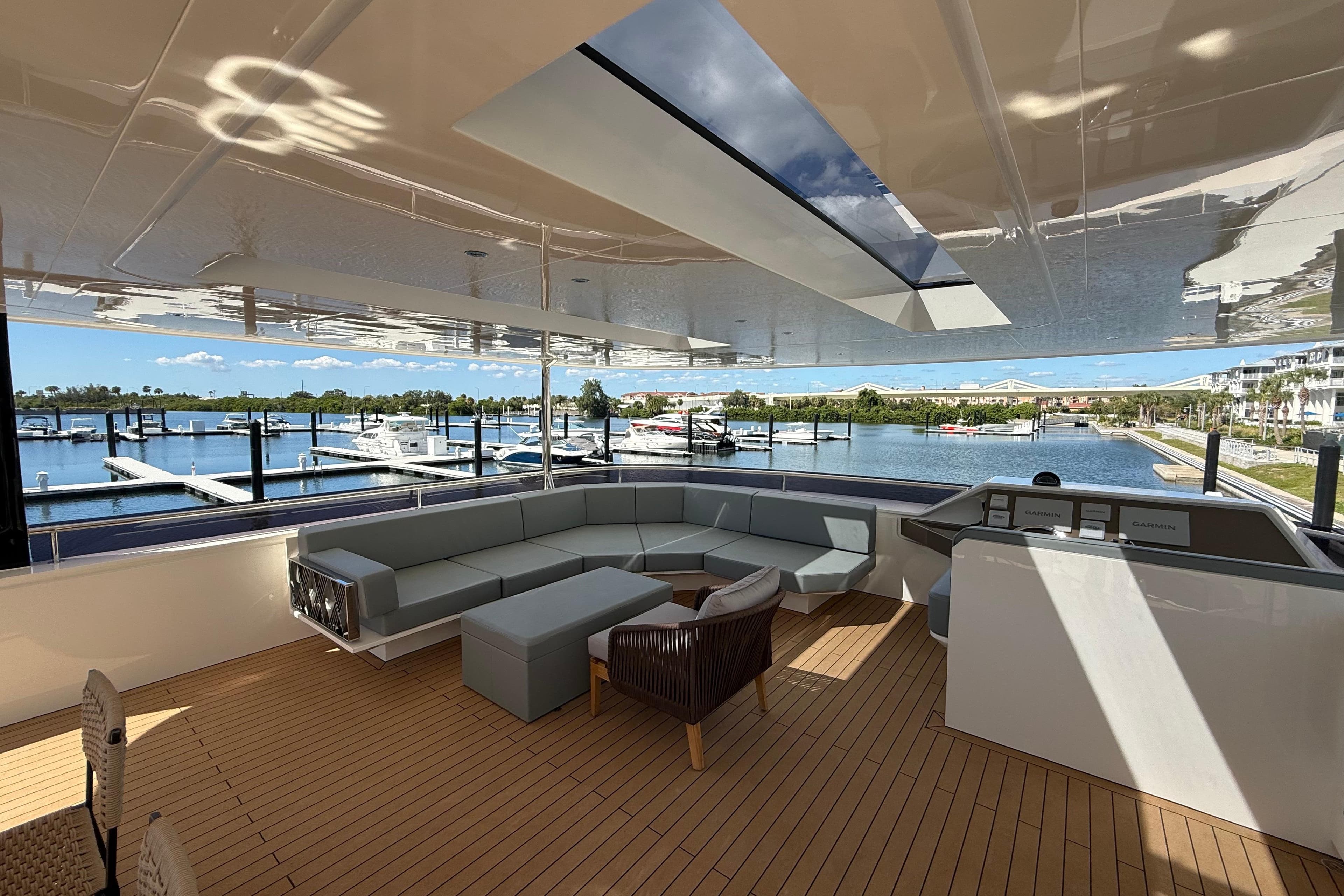 Luxurious Granocean W72 yacht interior with modern seating, overlooking marina, 2025 model.