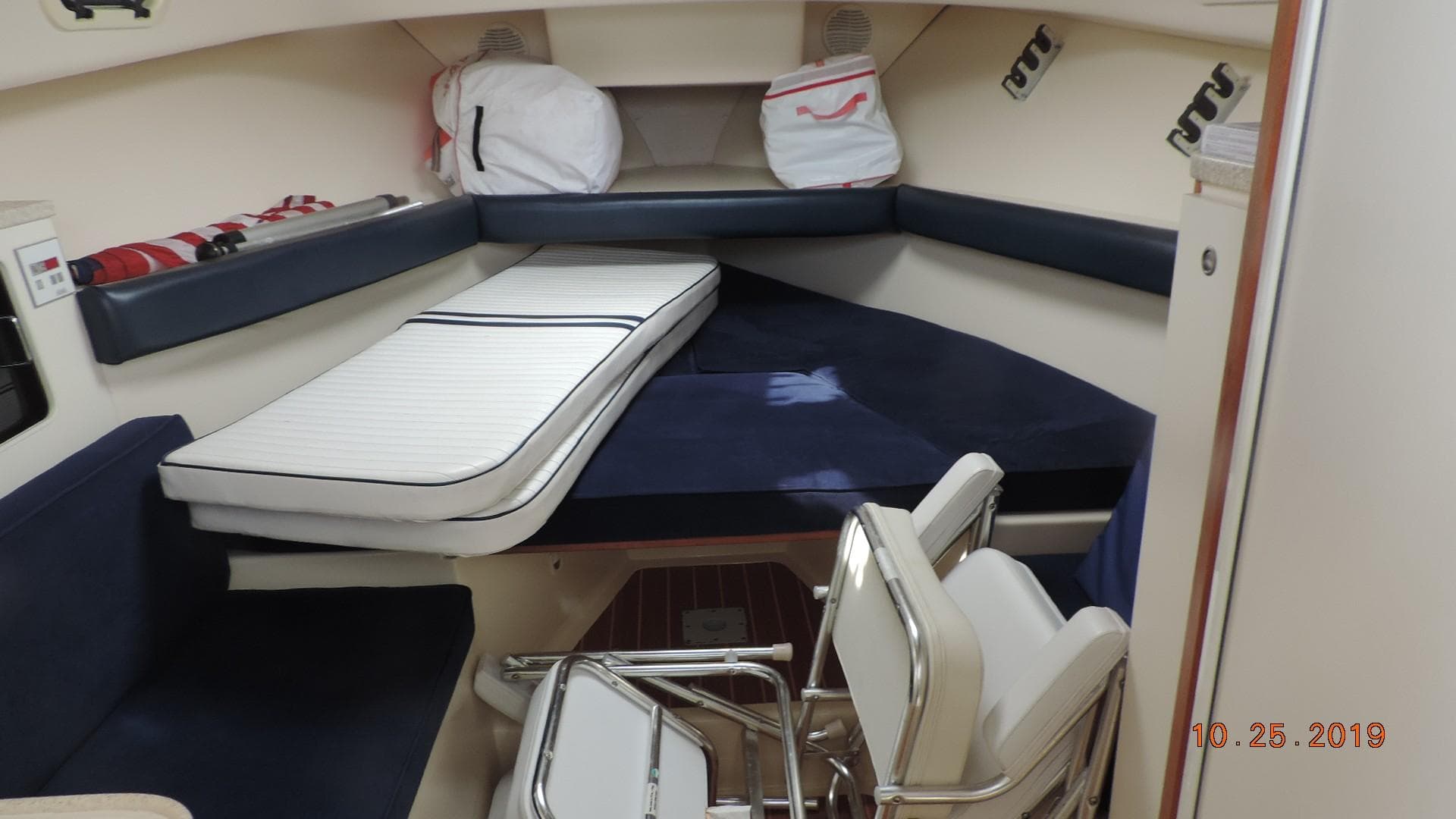 1998 Mainship 30 PILOT cabin interior with seating and storage.