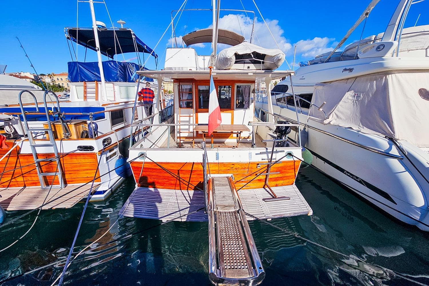 1980 Grand Banks 42 Europa yacht docked at marina, sunny day, clear blue sky.