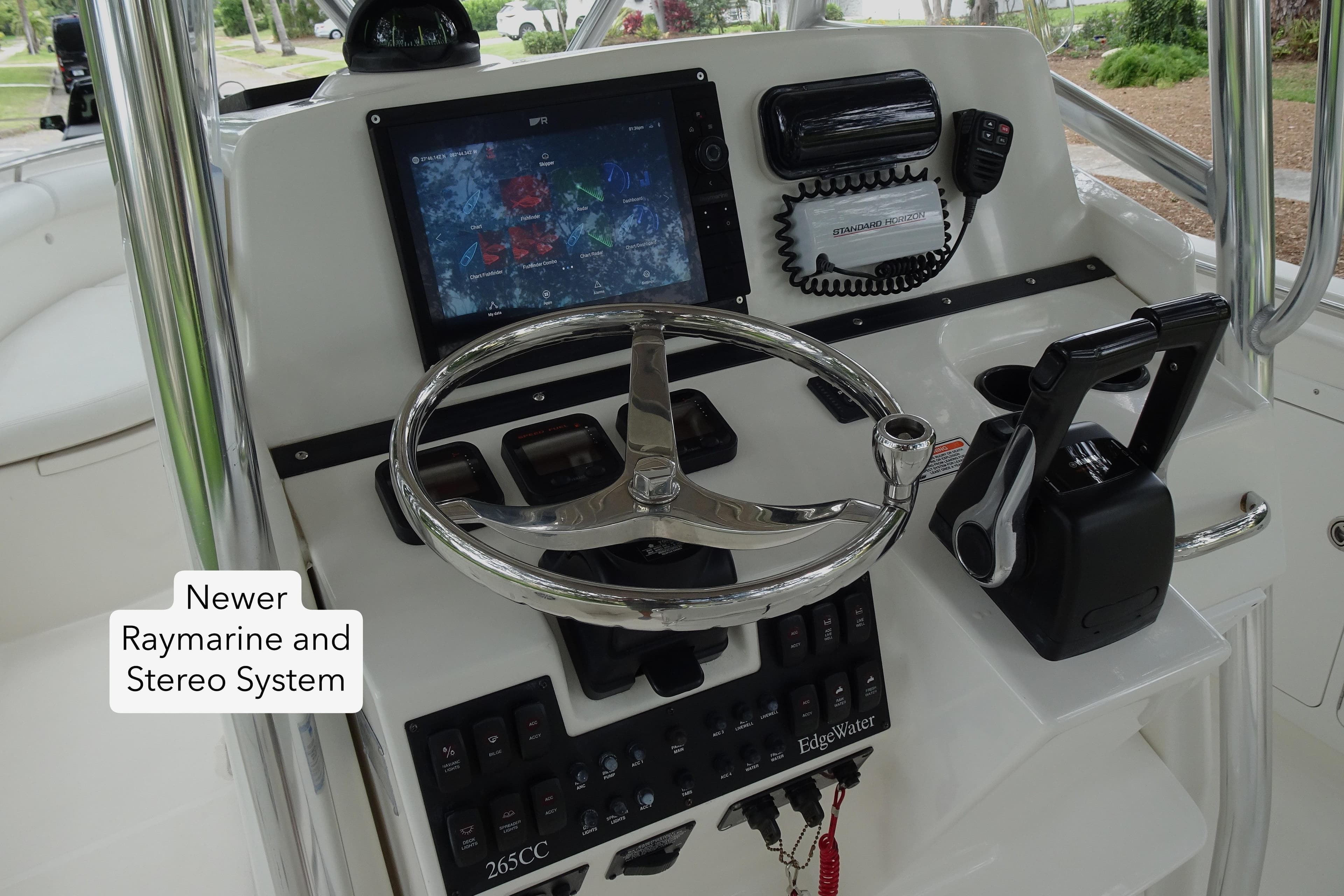 2006 Edgewater 265CC boat dashboard with newer Raymarine and stereo system.