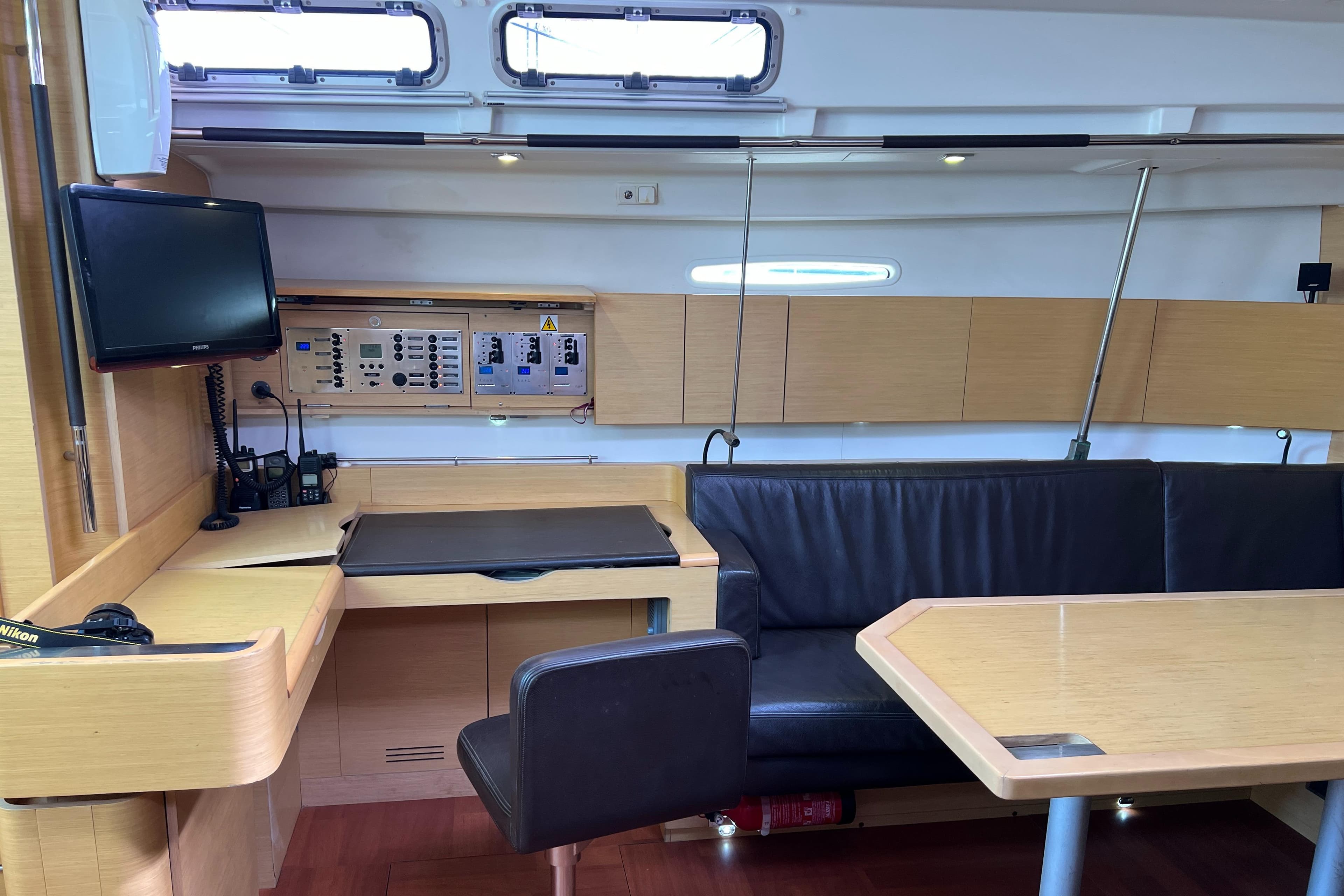 Interior of 2011 Beneteau First 50 yacht with modern navigation station and seating area.