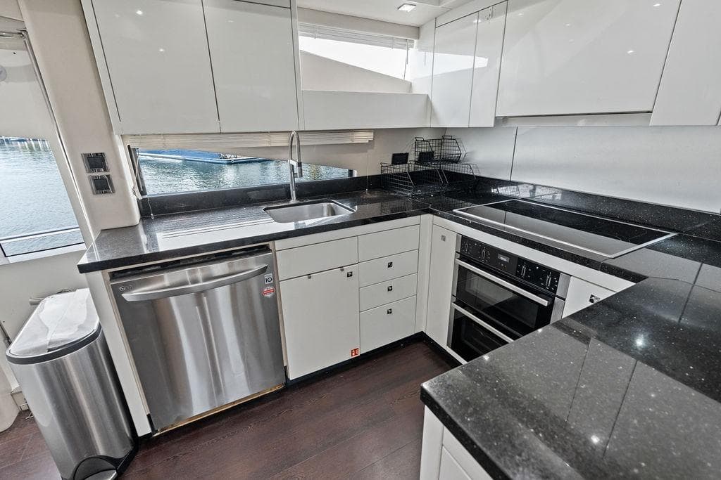 Modern kitchen interior on 2012 Sunseeker 88 Yacht with sleek countertops and stainless steel appliances.
