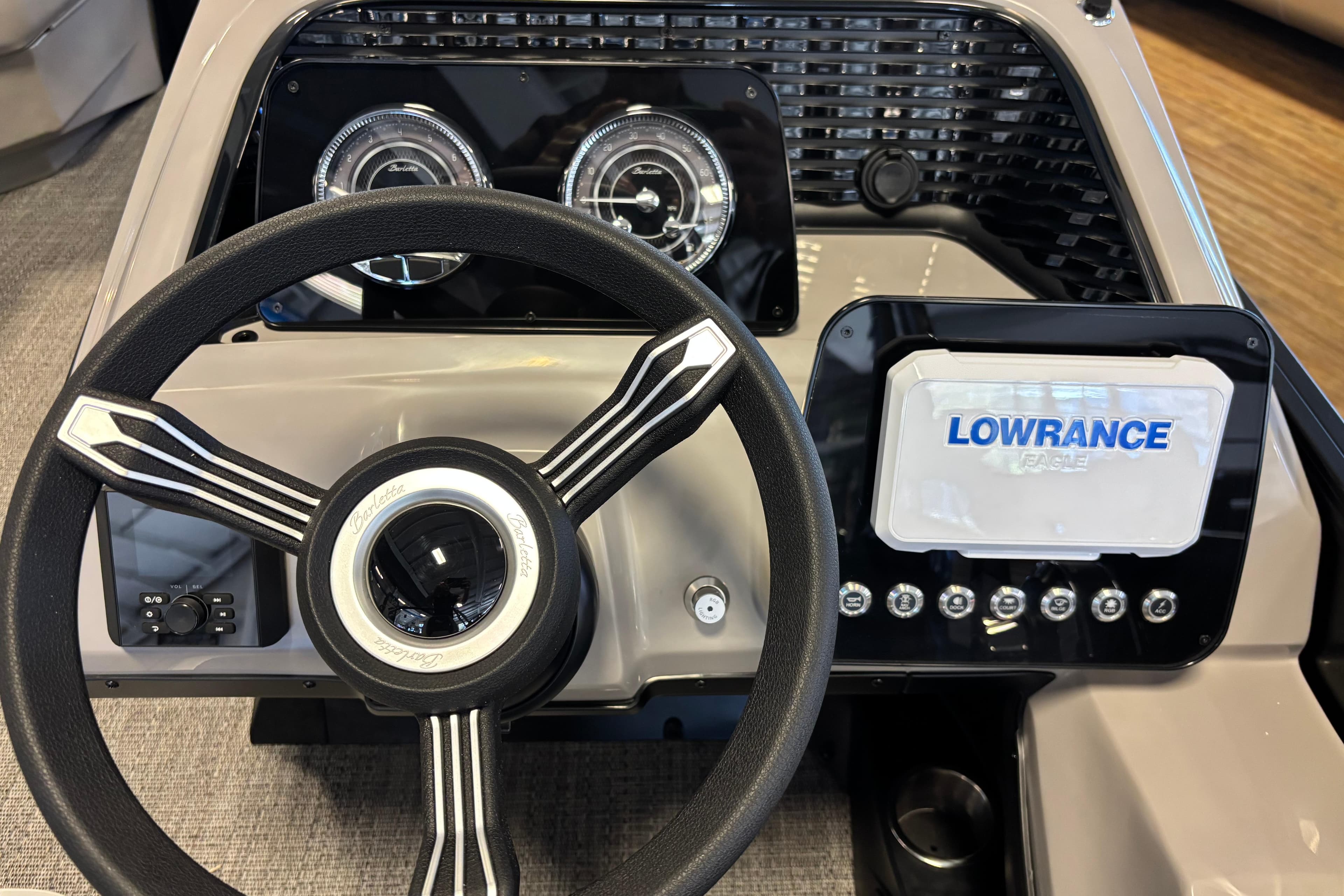 Steering console of 2026 Barletta ARIA 22UC with Lowrance display and gauges.