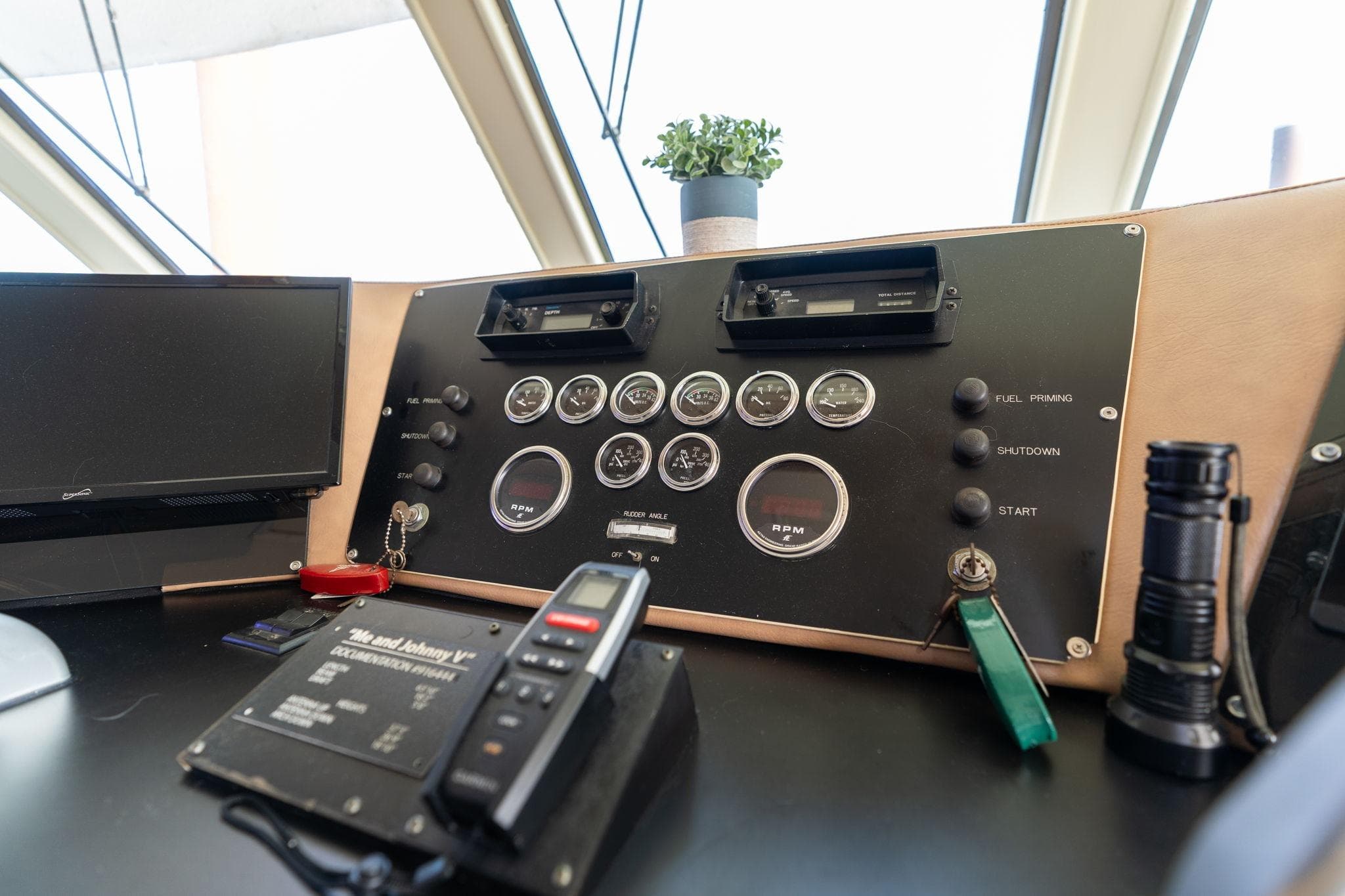 Control panel of a 1986 Hatteras 63 Motor Yacht with gauges and equipment.