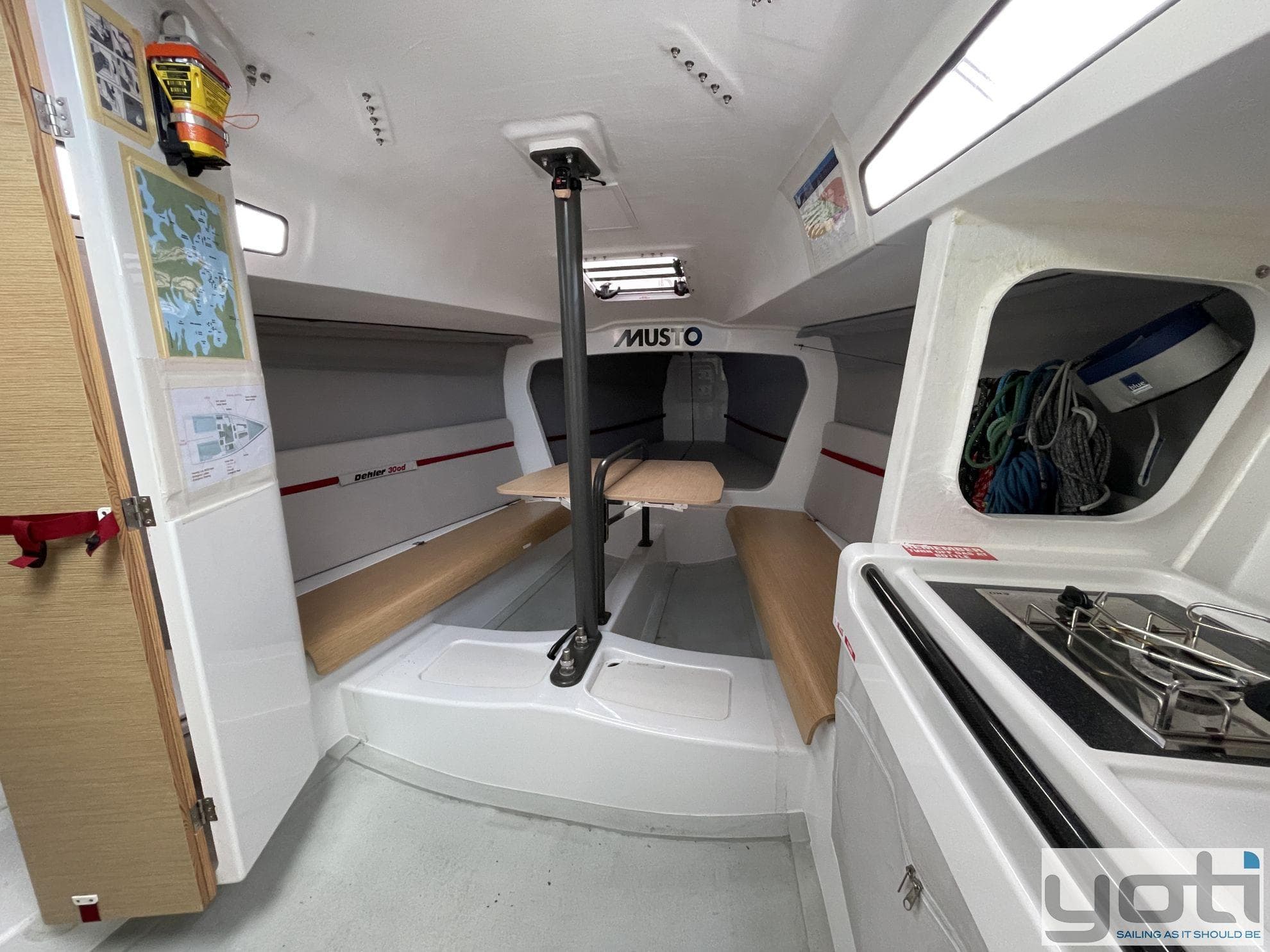 Interior of 2020 Dehler 30od sailboat with seating and compact kitchen area.